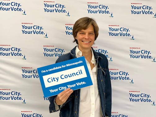 Minneapolis City Council Ward 12 candidate Becka Thompson holding a sign.