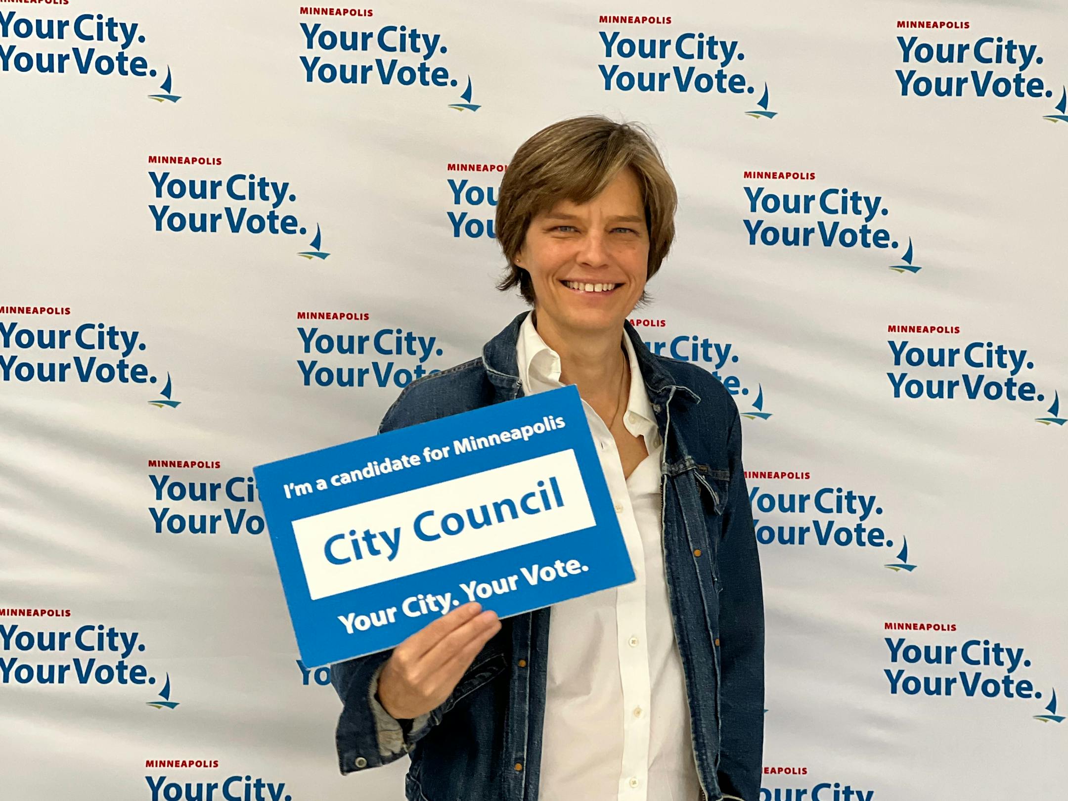 Minneapolis City Council Ward 12 candidate Becka Thompson holding a sign.