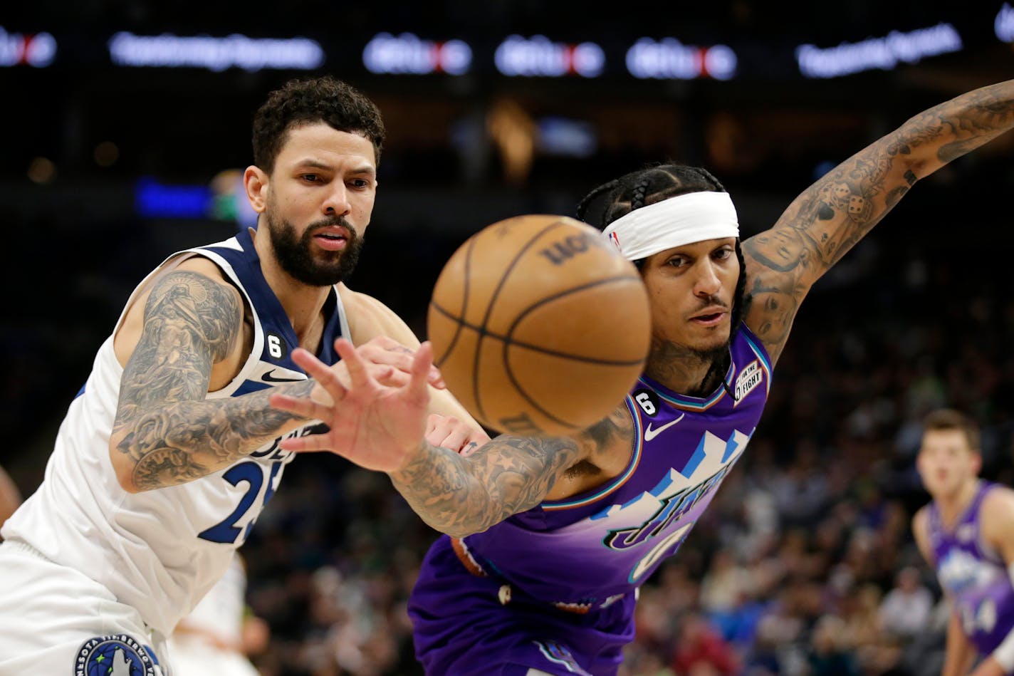 Minnesota Timberwolves guard Austin Rivers, left, and Utah Jazz guard Jordan Clarkson, right, vie for the ball in the third quarter of an NBA basketball game Monday, Jan. 16, 2023, in Minneapolis. (AP Photo/Andy Clayton-King)