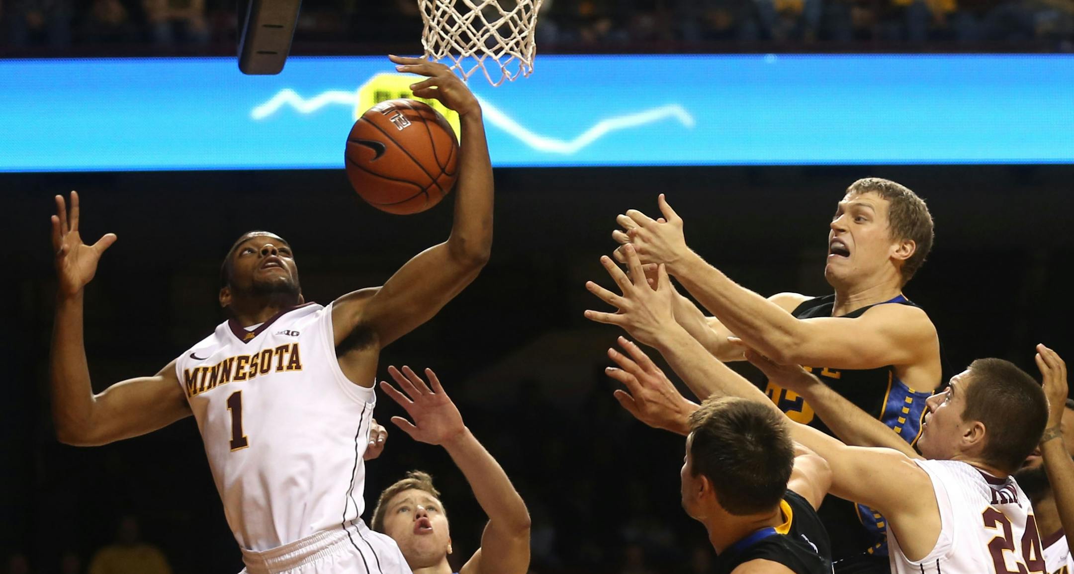 Gopher Andre Hollins snared an offensive rebound during the second half at Williams Arena in Minneapolis Tuesday, December 10, 2013.