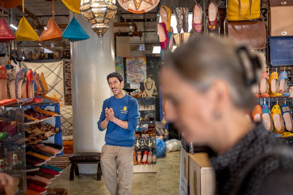 Mostafa Khchich welcomes customers into his store Dar Medina, in Minneapolis, Minn., on Thursday, May 12, 2022. Khchich sales Moroccan rugs, leather b
