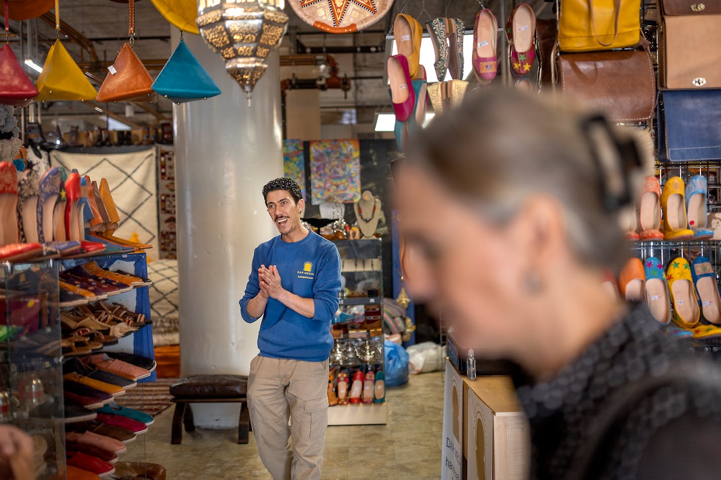 Mostafa Khchich welcomes customers into his store Dar Medina, in Minneapolis, Minn., on Thursday, May 12, 2022. Khchich sales Moroccan rugs, leather bags and other goods and is located in the Midtown Global Market. Business still hasn't returned to 2019 levels. ] Elizabeth Flores • liz.flores@startribune.com