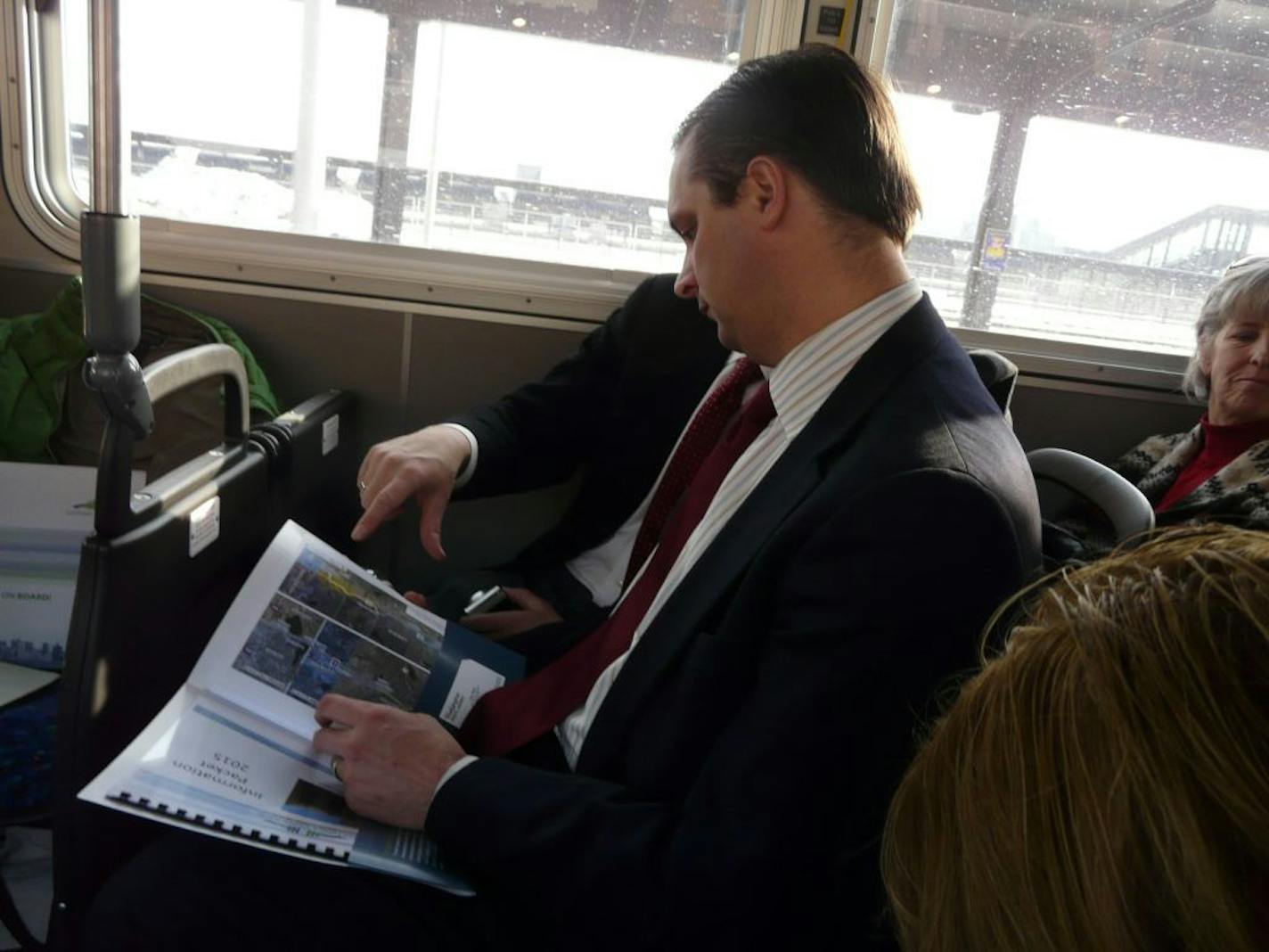 Met Council Chair Adam Duininck hears about plans for the Gold Line rapid busway during a bus tour earlier this month.