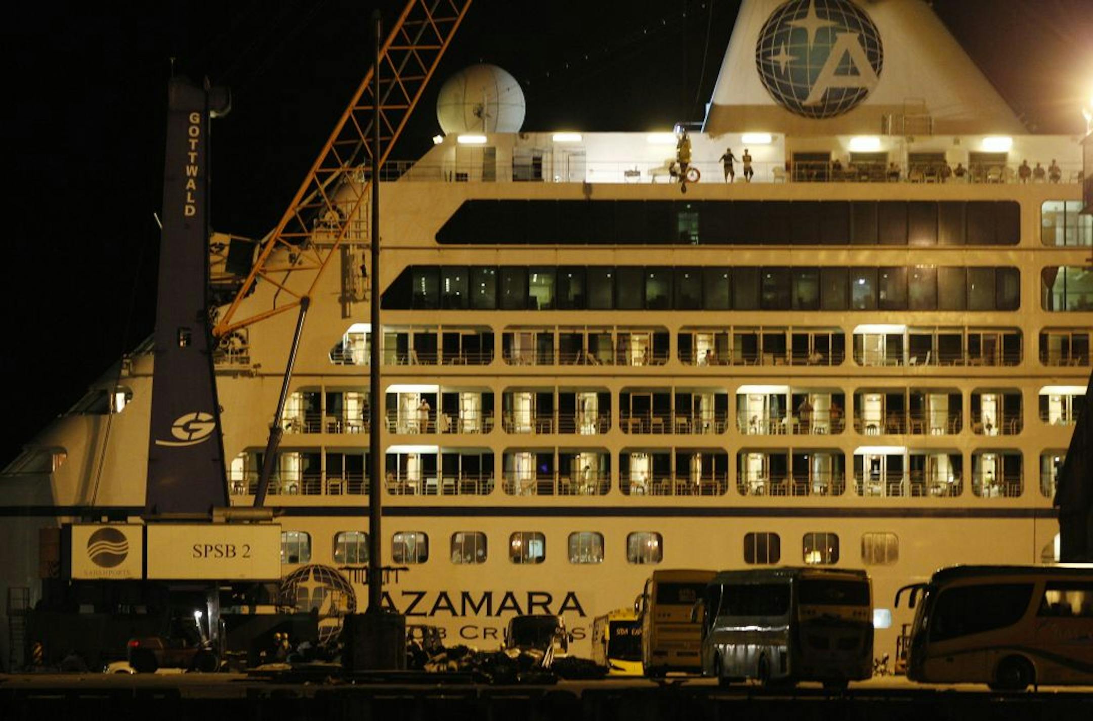Buses wait to ferry passengers on the wharf next to the docked Azamara Quest cruise ship at the port in Sandakan, Malaysia, Sunday, April 1, 2012. The Azamara Quest carrying 590 passengers and 411 crew, was left adrift for 24 hours after a fire broke out in one of the ships engine rooms on Friday night.