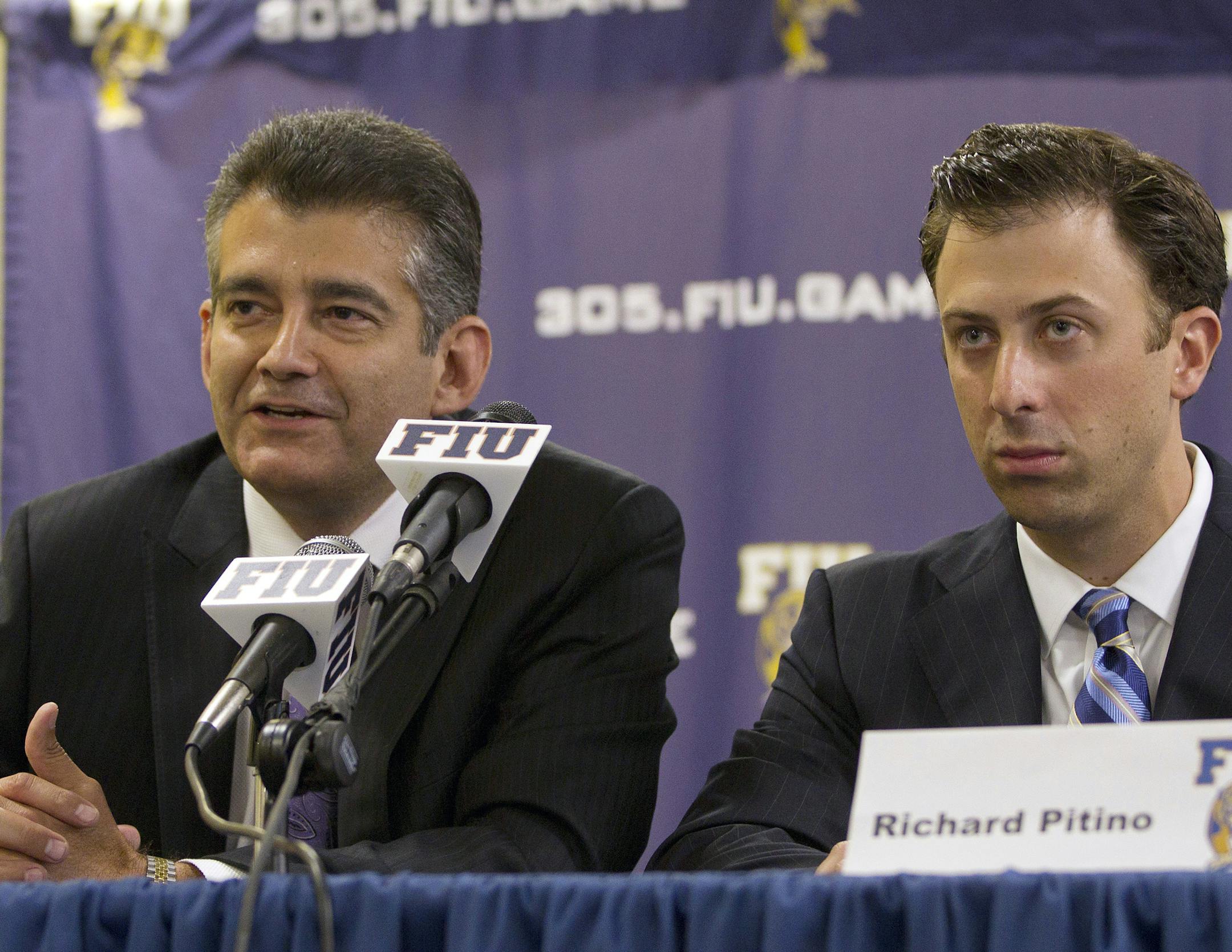 Florida International Vice President Pete Garcia, left, and Richard Pitino talk to the media during a press conference in Miami, Monday, April 16, 2012, where it was announced that Pitino had been hired to replace Isiah Thomas as head men's basketball coach. Pitino signed a five-year contract to take over a program that has not posted a winning season in 12 years. The 29-year-old Pitino is the son of Louisville coach Rick Pitino. (AP Photo/J Pat Carter) ORG XMIT: FLJC101