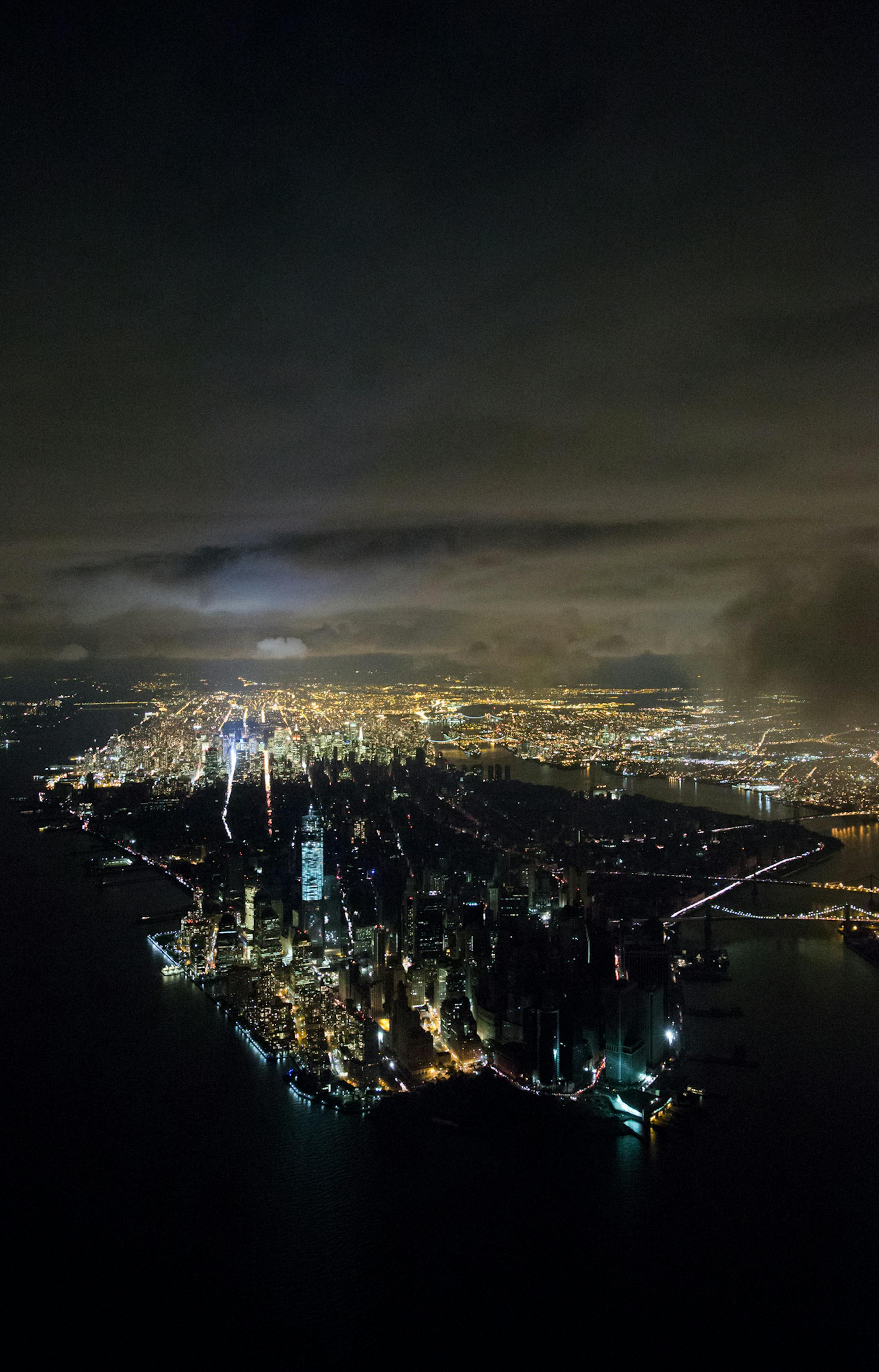 NEW YORK, NY - NOVEMBER 1: (EXCLUSIVE COVERAGE - PREMIUM RATES APPLY) Aerial view shot at night shows Manhattan in the aftermath of superstorm Sandy, including the blackout from the powercut south of 39th street on October 31- November 1, 2012 in New York City. (Photo by Iwan Baan/Reportage by Getty Images) ORG XMIT: 156055024