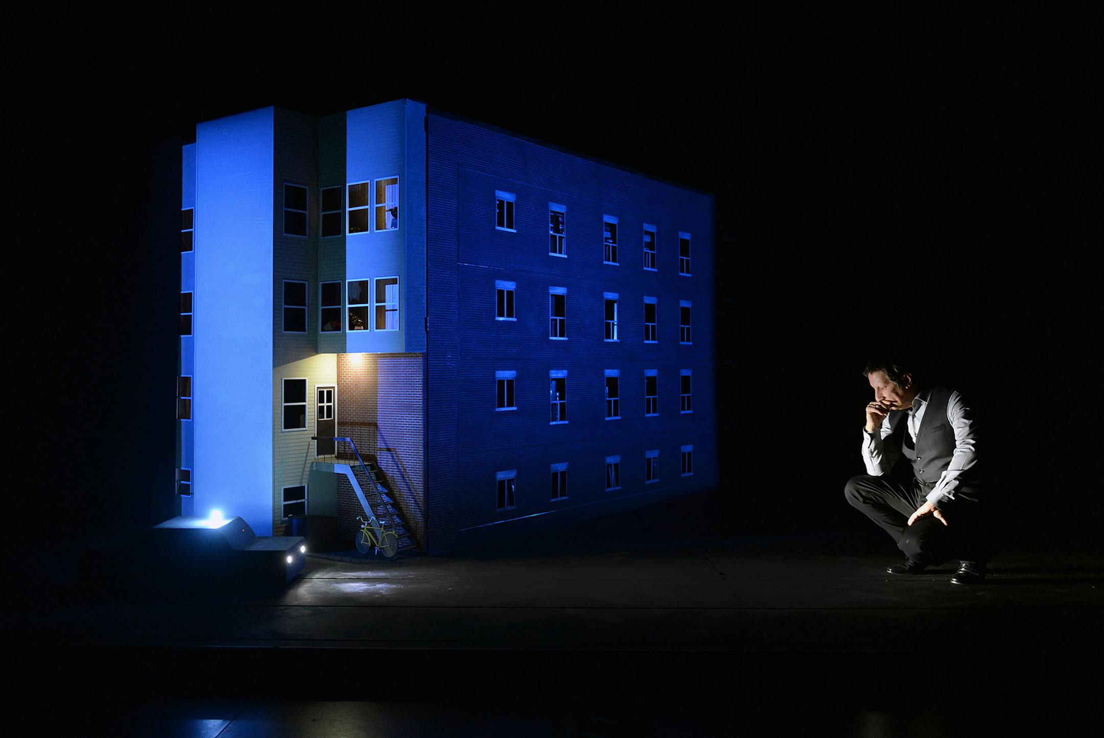 Robert Lepage with a replica of his childhood apartment building.