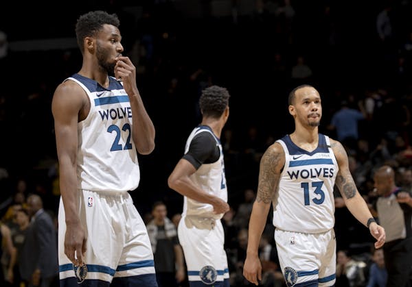Minnesota Timberwolves forward Andrew Wiggins (22) and Shabazz Napier (13) walked off the court at the end of the game.