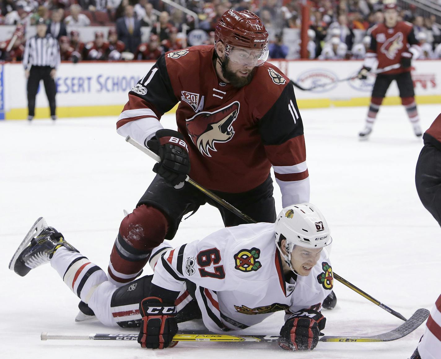 Arizona Coyotes center Martin Hanzal (11) checks Chicago Blackhawks center Tanner Kero in the second period during an NHL hockey game, Thursday, Feb. 2, 2017, in Glendale, Ariz. (AP Photo/Rick Scuteri) ORG XMIT: AZRS107