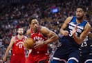 Toronto Raptors guard DeMar DeRozan (10) moves in on Minnesota Timberwolves Karl-Anthony Towns, right, during the first half of an NBA basketball game