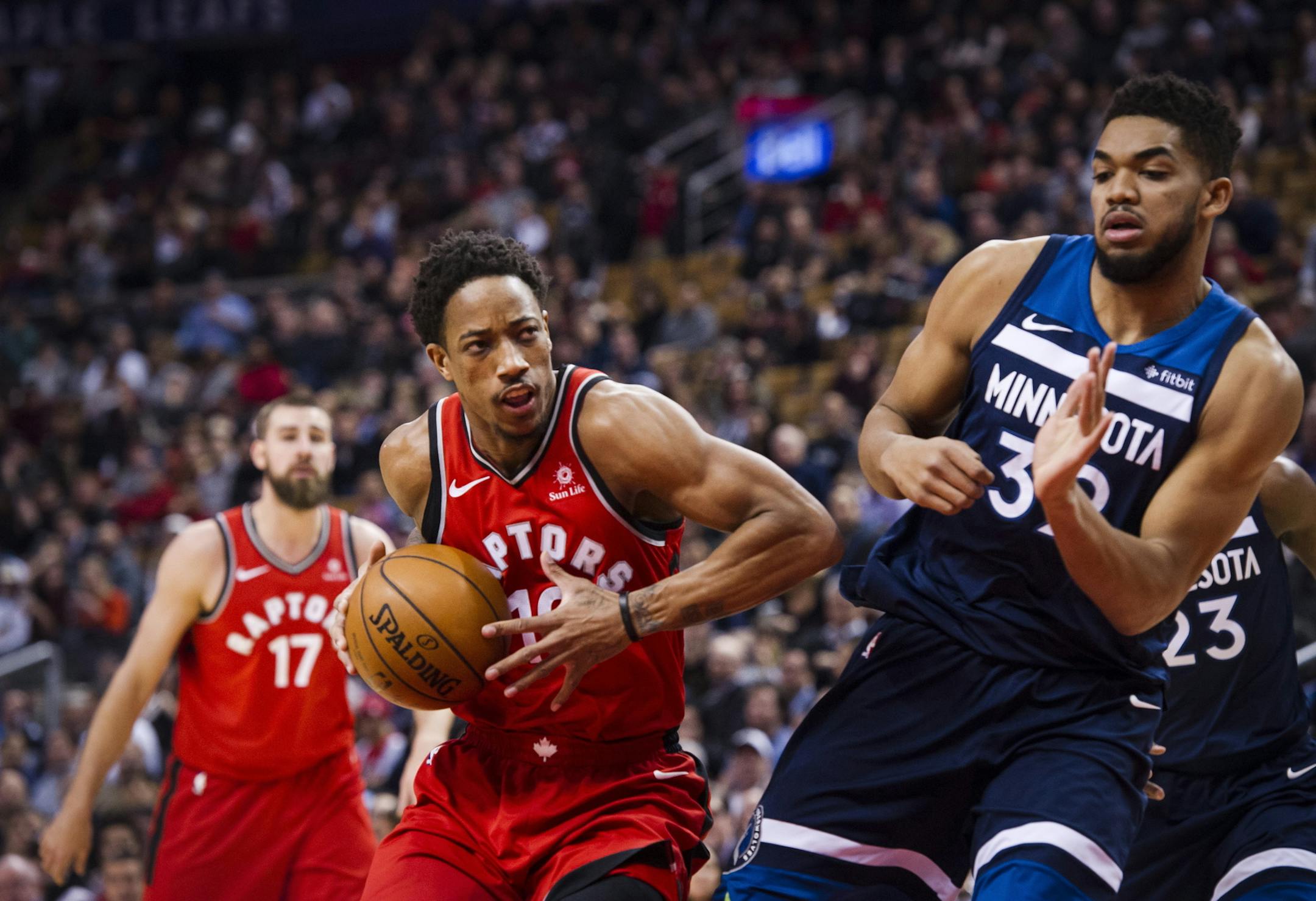 Toronto Raptors guard DeMar DeRozan (10) moves in on Minnesota Timberwolves Karl-Anthony Towns, right, during the first half of an NBA basketball game, Tuesday, Jan. 30, 2018 in Toronto. (Christopher Katsarov/The Canadian Press via AP)