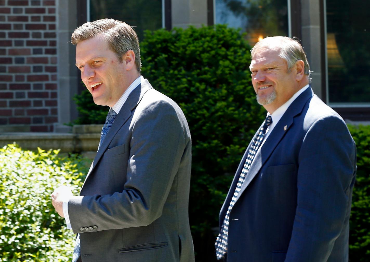 Republican House Speaker Kurt Daudt, left, and Senate Majority Leader Tom Bakk smile at reporters as they arrive at the governor's residence earlier this week.