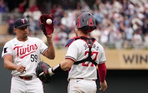 Twins closer Jhoan Duran celebrates with catcher Ryan Jeffers after pitching a 1-2-3 ninth to earn a save in Saturday's 5-3 victory over the Rangers a