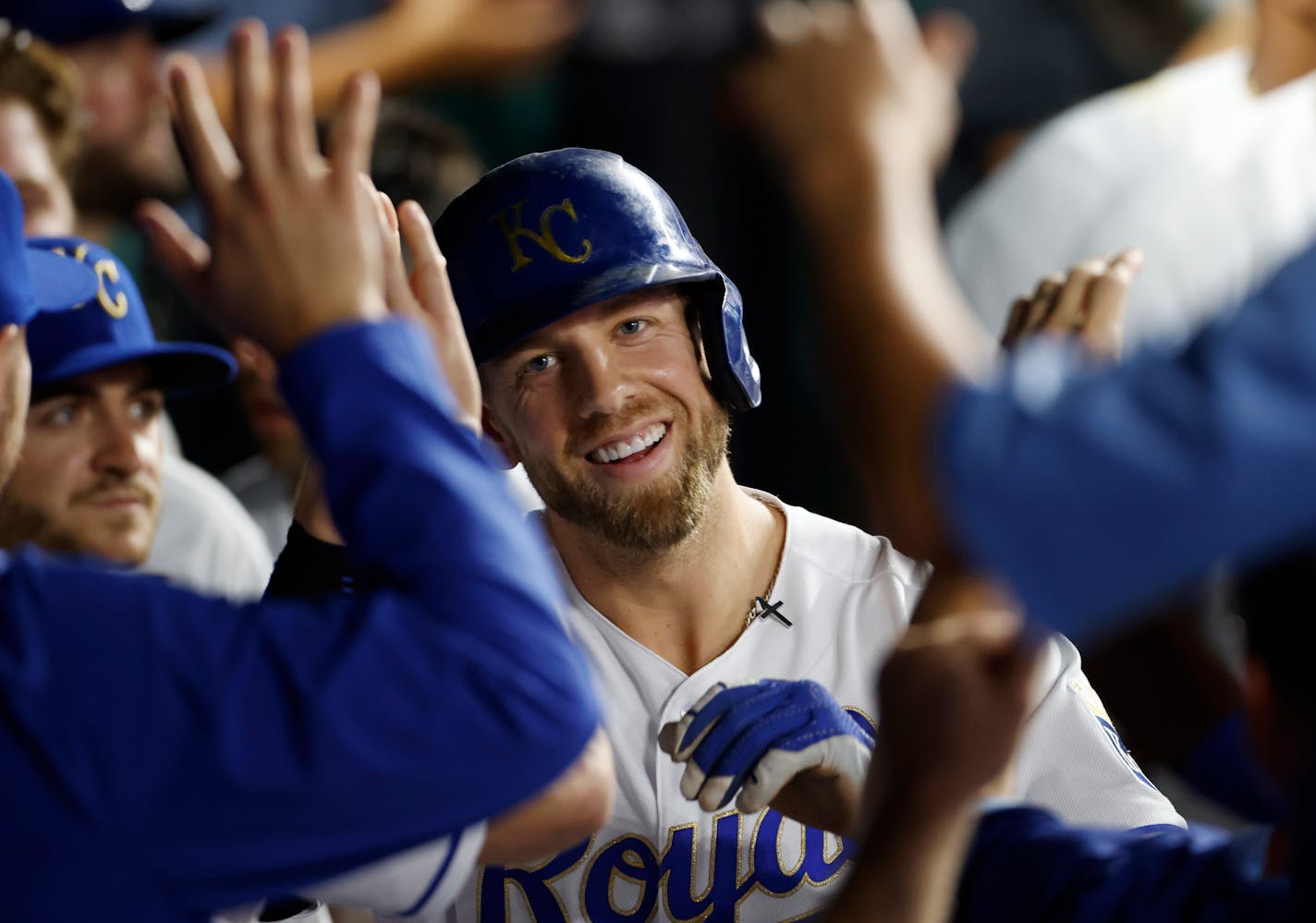 Kansas City Royals' Hunter Dozier reacts in the dugout after hitting a home run during the fifth inning of a baseball game against the Minnesota Twins in Kansas City, Mo., Friday, Oct. 1, 2021. (AP Photo/Colin E. Braley)