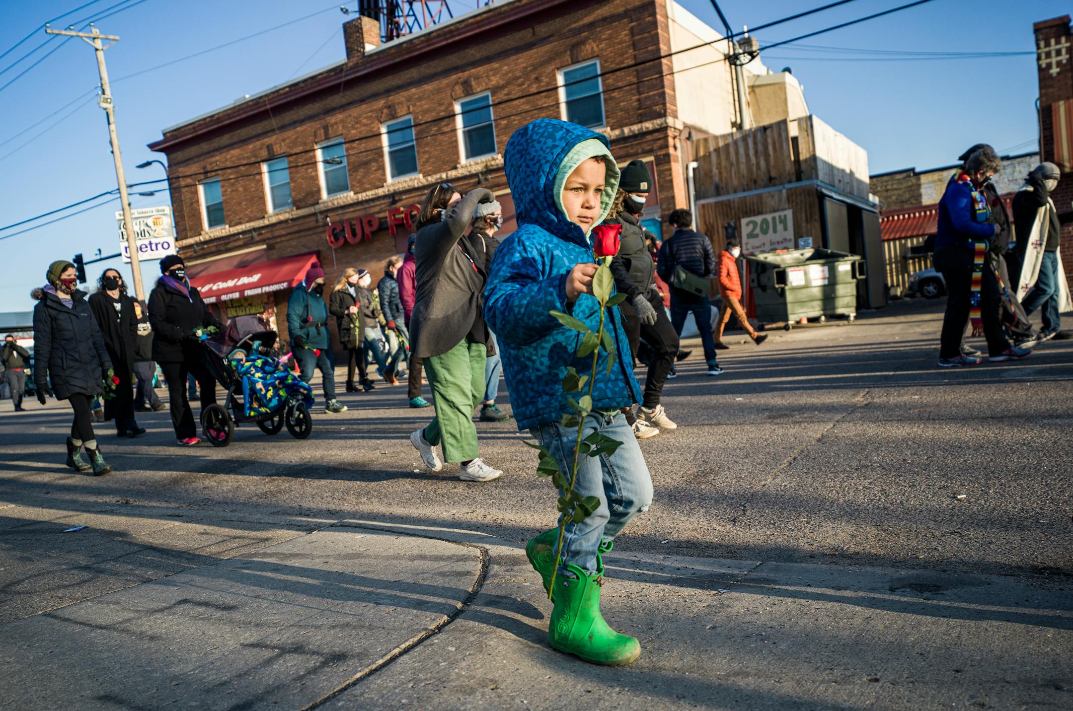 Mateo Austin, 4, joined his parents as they gathered in a walk and prayer early near Cup Foods in the morning before opening statements are to begin in the Derek Chauvin trial.