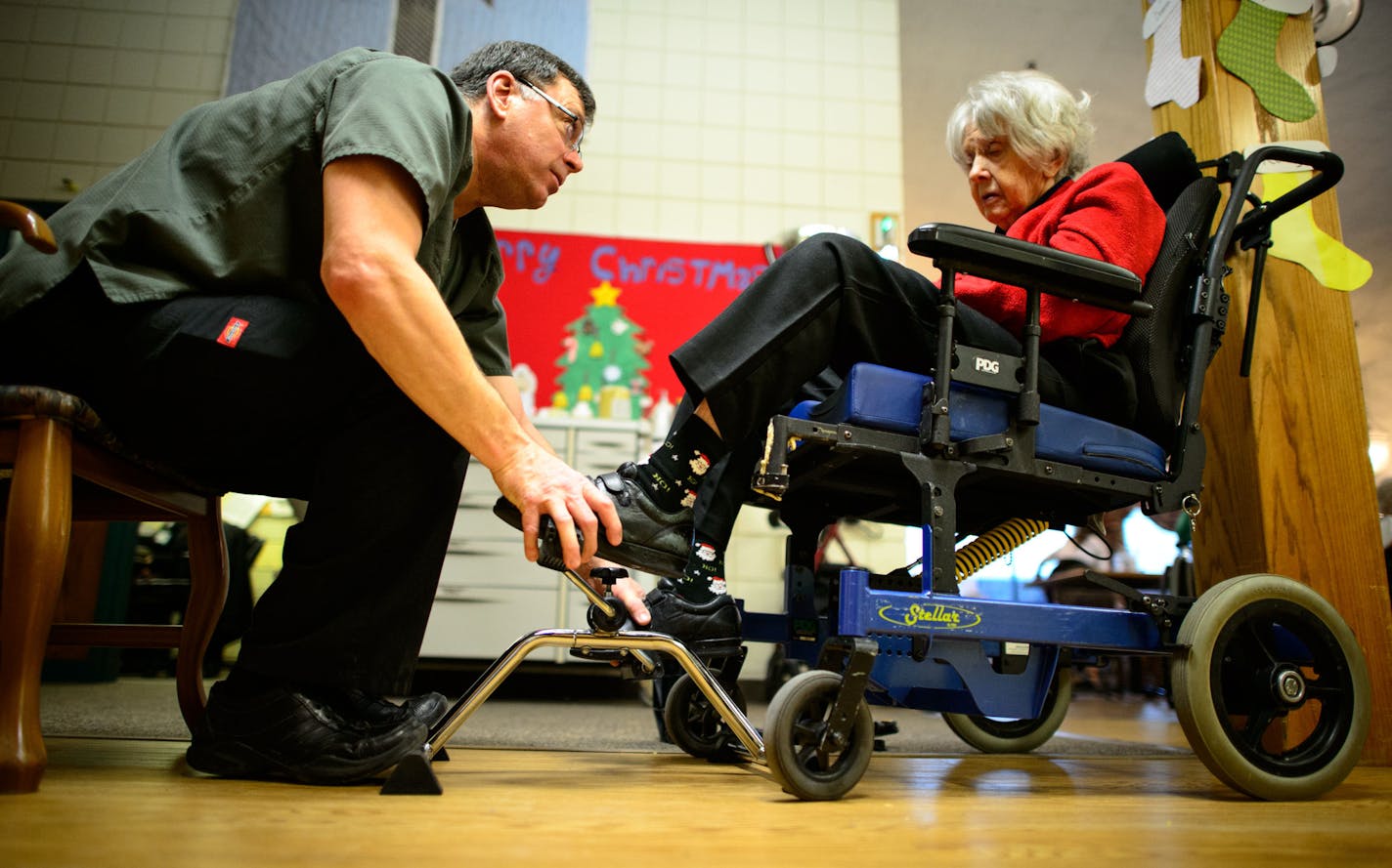 CNA Rick Pavlisich helped Ruby Johnson get her feet into a restorator that mimics the action of a bicycle to exercise her legs, an important part of the Awakenings program. Pavlisich lead an activity at Ecumen Parmly LifePointes nursing home, Chisago City, for dementia patients participating in the Ecumen Awakenings program, which uses behavior modification to reduce the need for antipsychotic medications. Friday, December 13, 2013 ] GLEN STUBBE * gstubbe@startribune.com