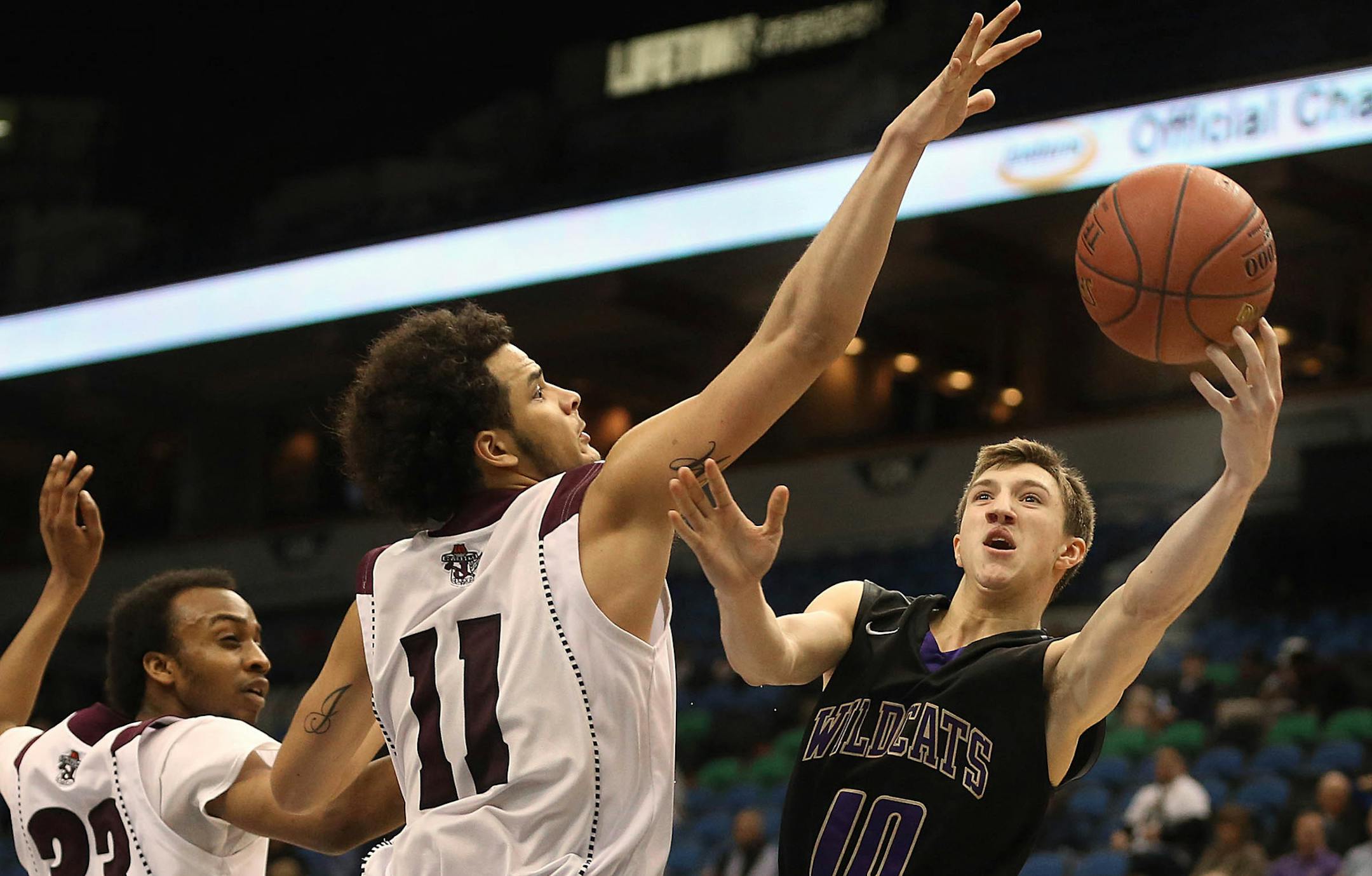 Waconiaís Ryan Kruchten tried to shoot around Johnson defenders Derek Siedschlag (left) and Justus Murphy. ] JIM GEHRZ ï james.gehrz@startribune.com / Minneapolis, MN / March 12, 2015 /12:00 PM ñ BACKGROUND INFORMATION: The St. Paul Johnson High School Governors played the Waconia Wildcats in the State Boys' Basketball Tournament Class 3A semifinals at the Target Center. Johnson won the game, 69-62.