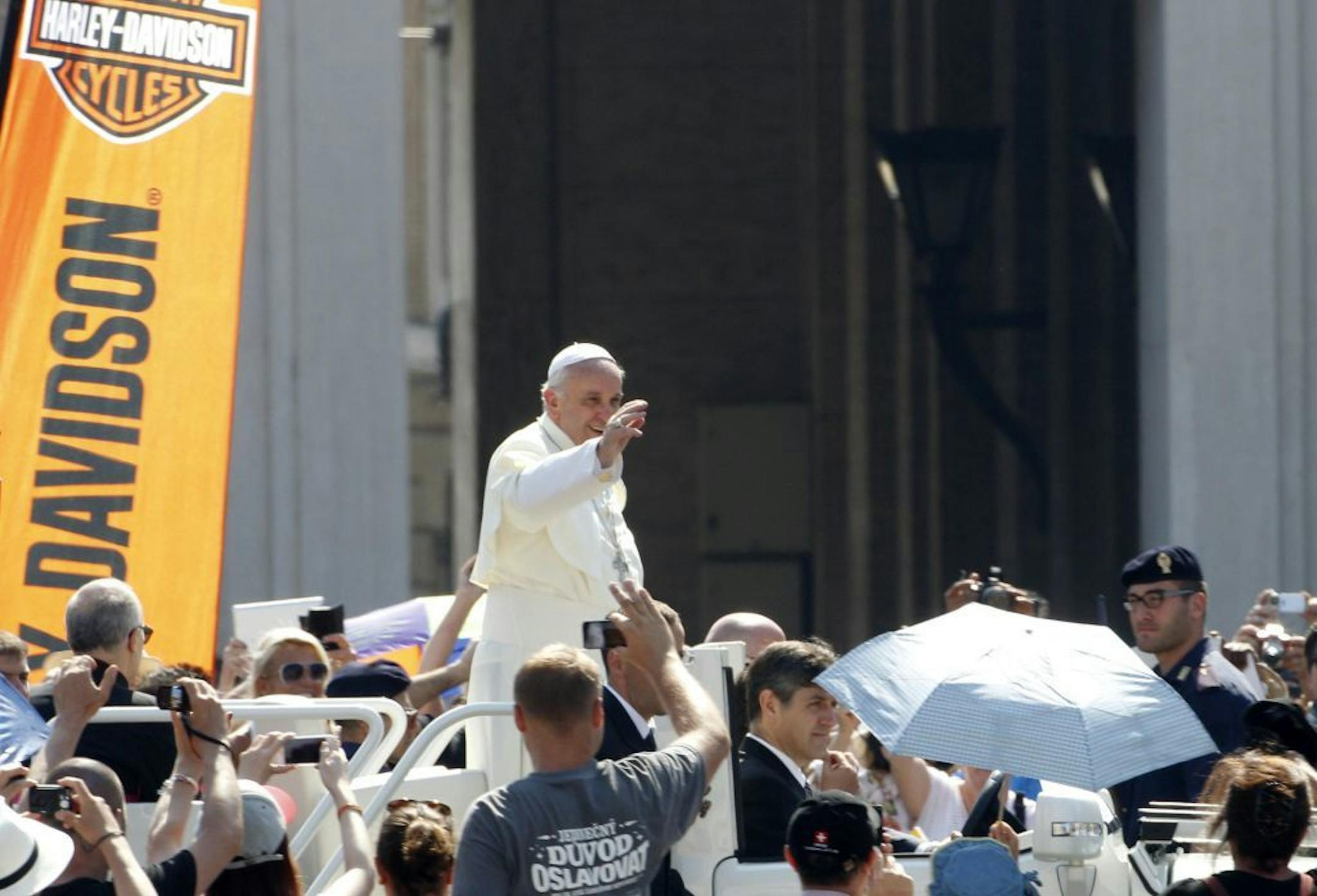 Pope Francis waves to faithful as he arrives for a Mass in St. Peter's Square at the Vatican, Sunday, June 16, 2013. The pontiff greeted hundreds of Harley Davidson riders and blessed their motorcycles prior to the start of the mass. The riders are gathered in Rome for a four-day event to celebrate the motorcycle company's 110th anniversary.