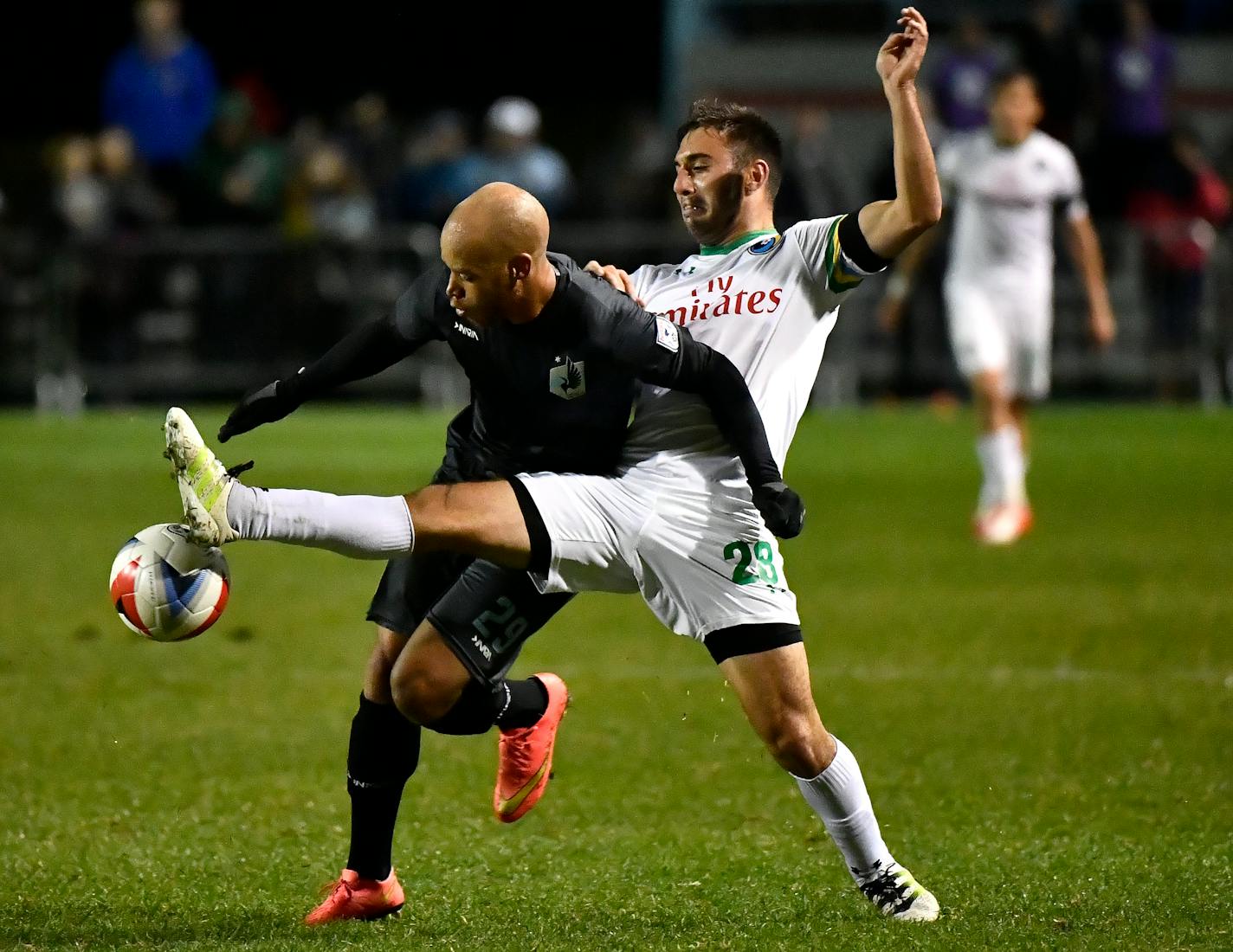 Minnesota United FC forward J.C. Banks (29) and New York Cosmos defender Jimmy Mulligan (28) battled for the ball in the first half.