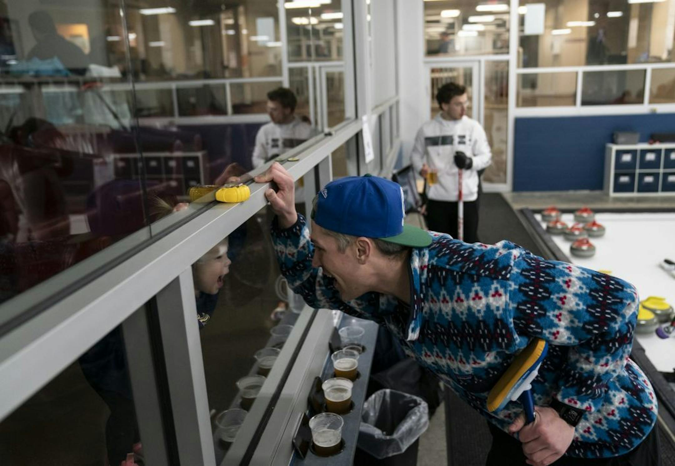Robert Panger made a goofy face with his daughter Sullivan Panger as she was peering through the restaurant glass watching him curling with his curling league at the Four Seasons Curling Club in Blaine, Minn., Wednesday, January 29, 2020.