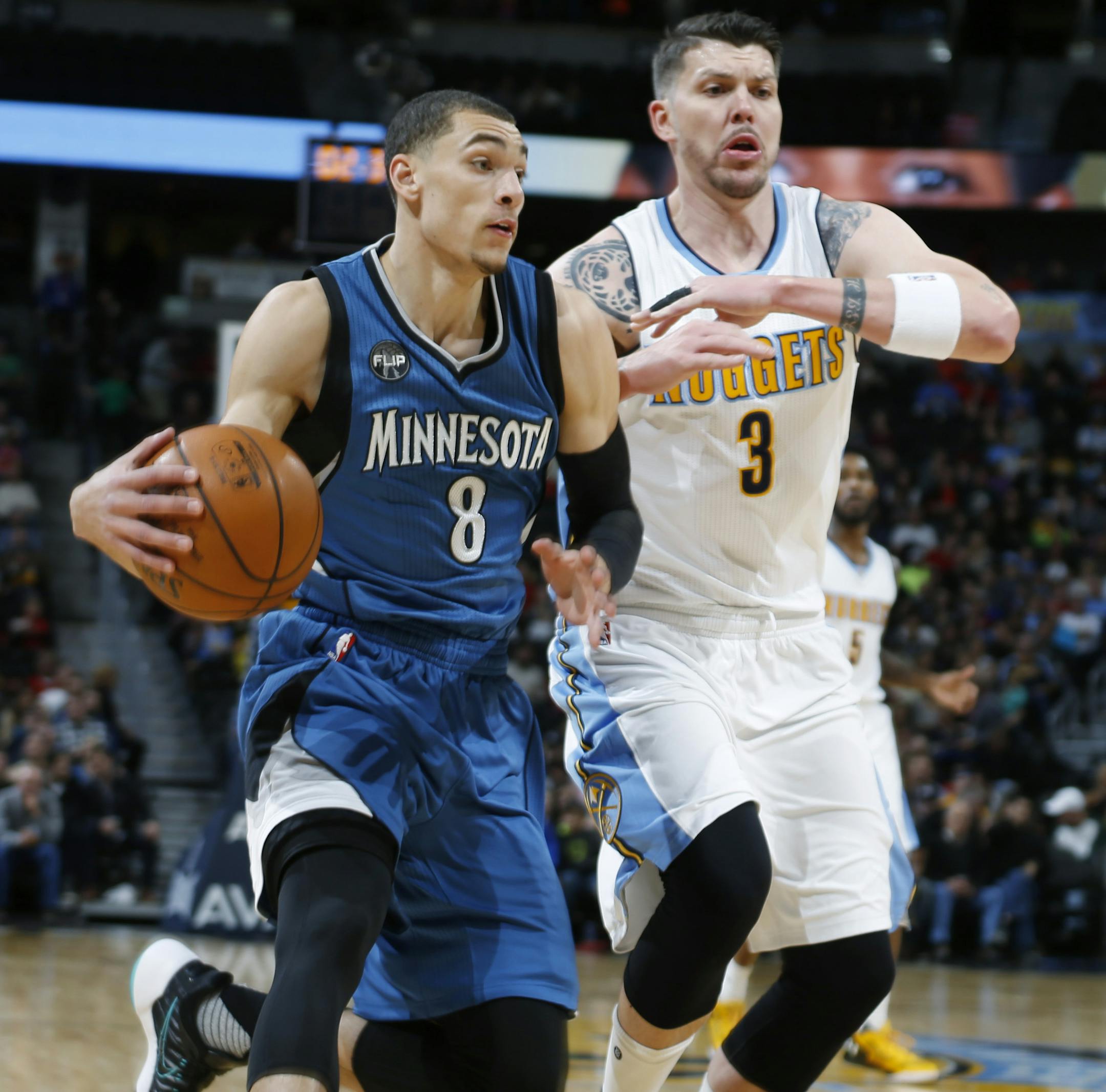 Minnesota Timberwolves guard Zach LaVine, left, drives past Denver Nuggets guard Mike Miller for a shot in the first half of an NBA basketball game Friday, Dec.11, 2015, in Denver. (AP Photo/David Zalubowski)