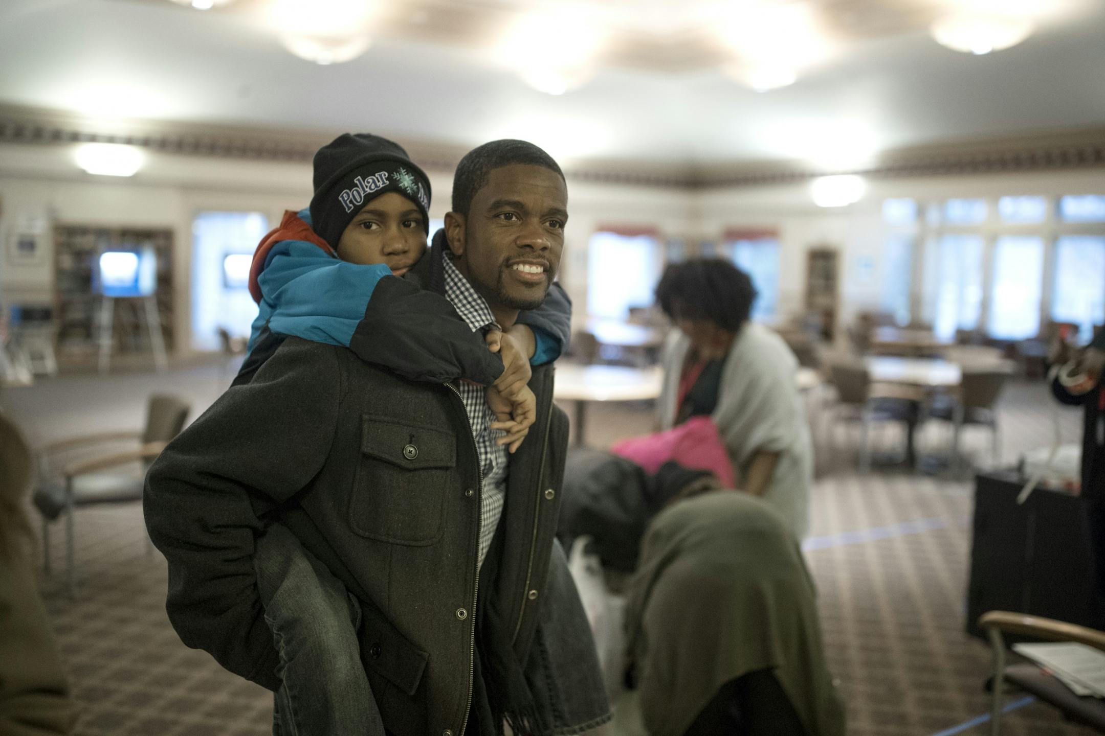 St. Paul mayoral candidate Melvin Carter gave his so Myles, 10, a piggyback ride after voting Tuesday morning at Ravoux Hi-Rise November 7,2017 in St. Paul, MN.