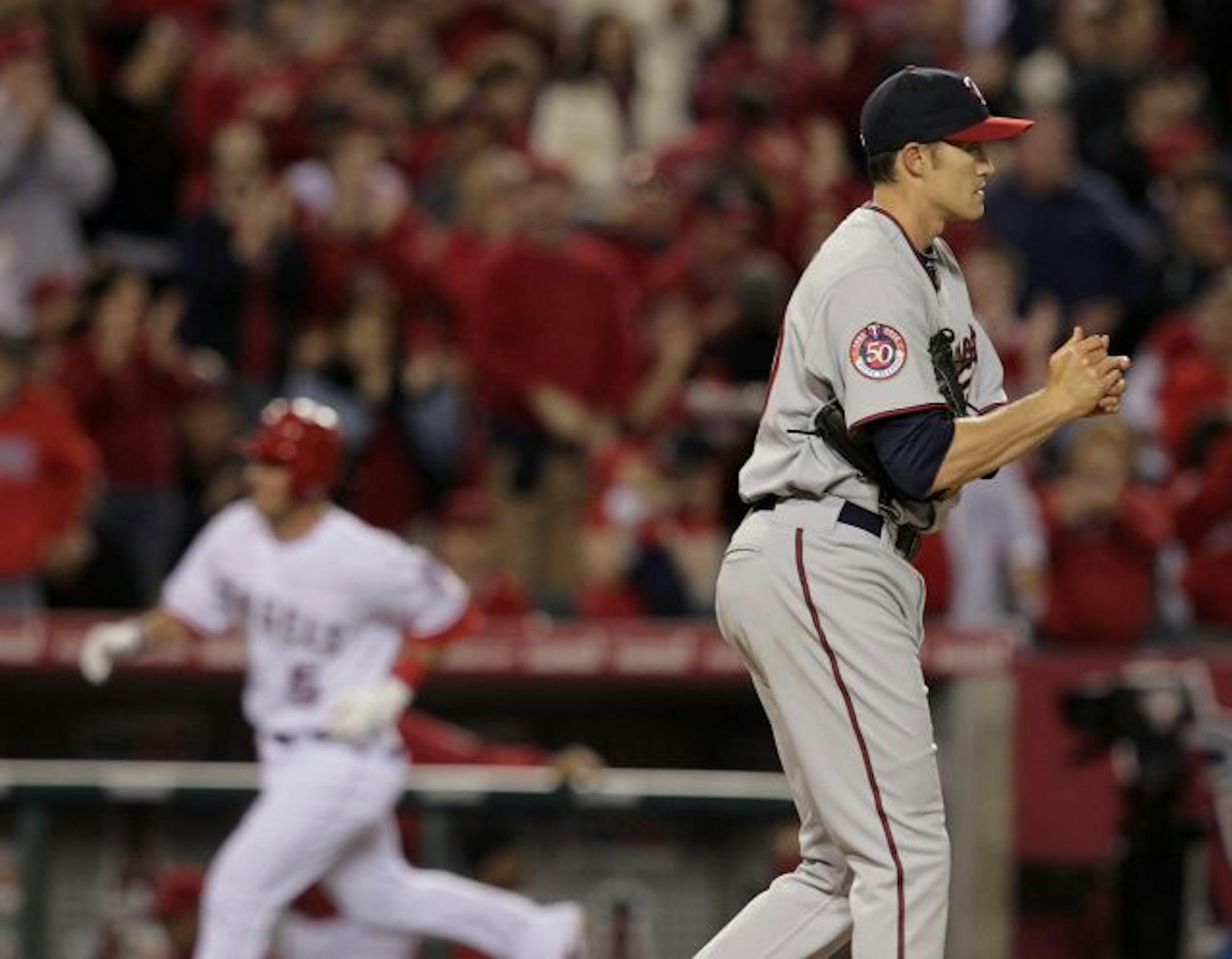 Twins starter Scott Baker rubbed up a new baseball as the Angels' Jeff Mathis rounded the bases after a second-inning home run Monday night.