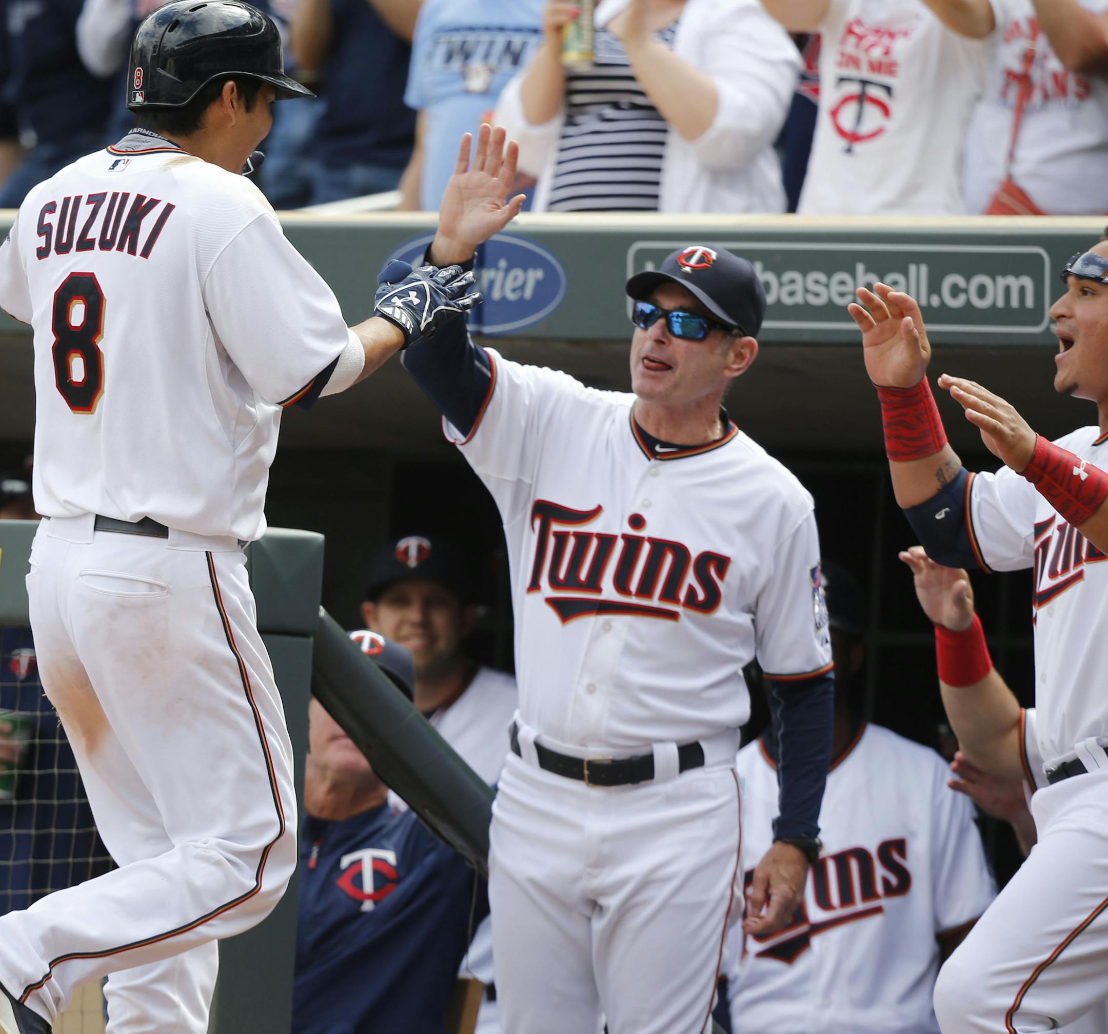 Minnesota Twins catcher Kurt Suzuki (8) is greeted in the dugout by manager Paul Molitor, middle, and teammate Oswaldo Arcia, right, after hitting a two-run 8th inning homerun against the Kansas City Royals. The Twins beat the Royals 8-5 Thursday, April 16, 2015, at Target Field in Minneapolis, MN.](DAVID JOLES/STARTRIBINE)djoles@startribune.com Minnesota Twins and the Kansas City Royals