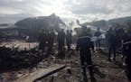 This image dated Wednesday, April 11, 2018, and posted by Algerian news agency ALG24, shows firefighters and soldiers at the scene of a fatal military