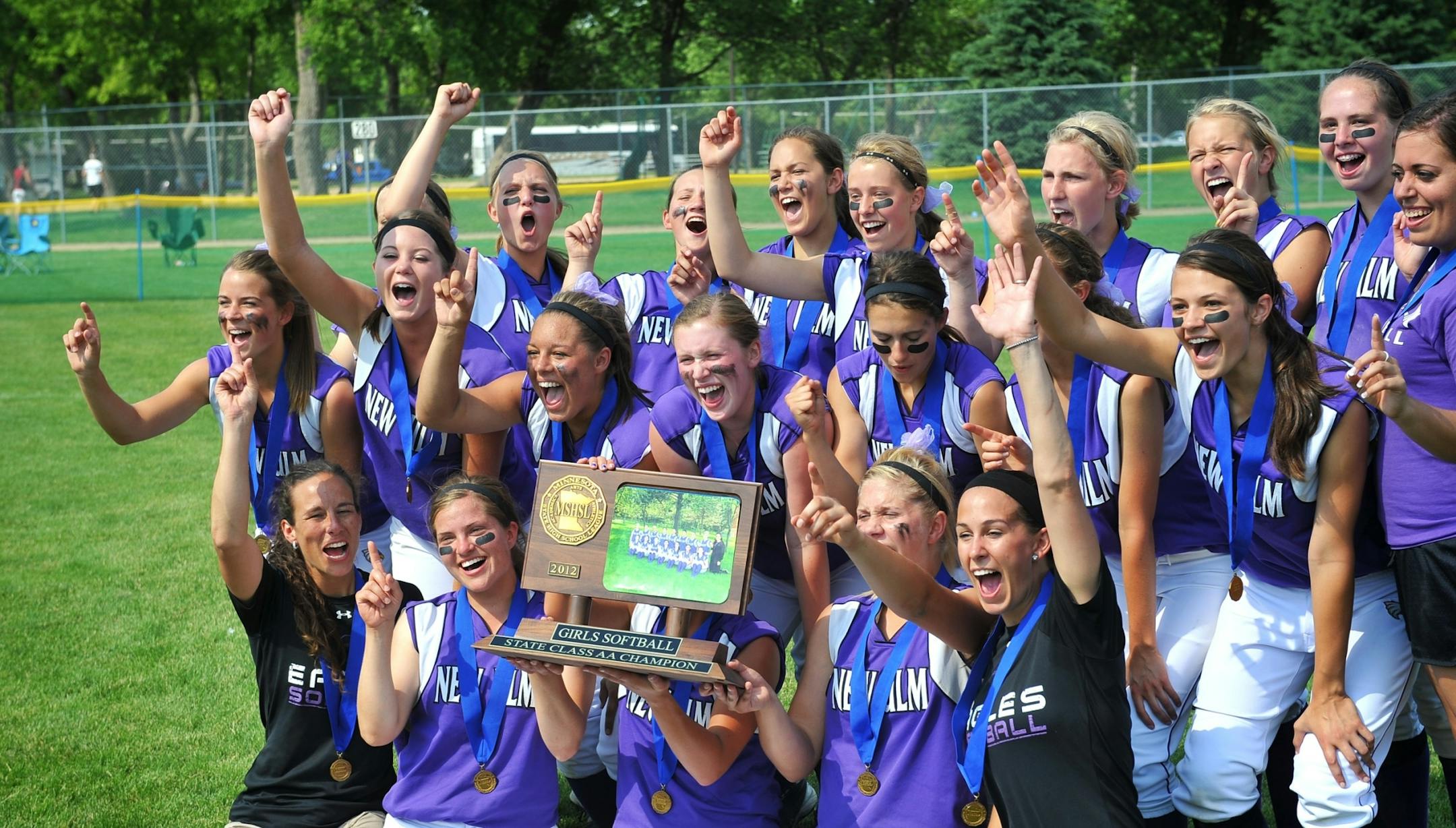 New Ulm players celebrate their win. New Ulm won the 2A game against St. Anthony Village 9-5, Friday, June 8, 2012