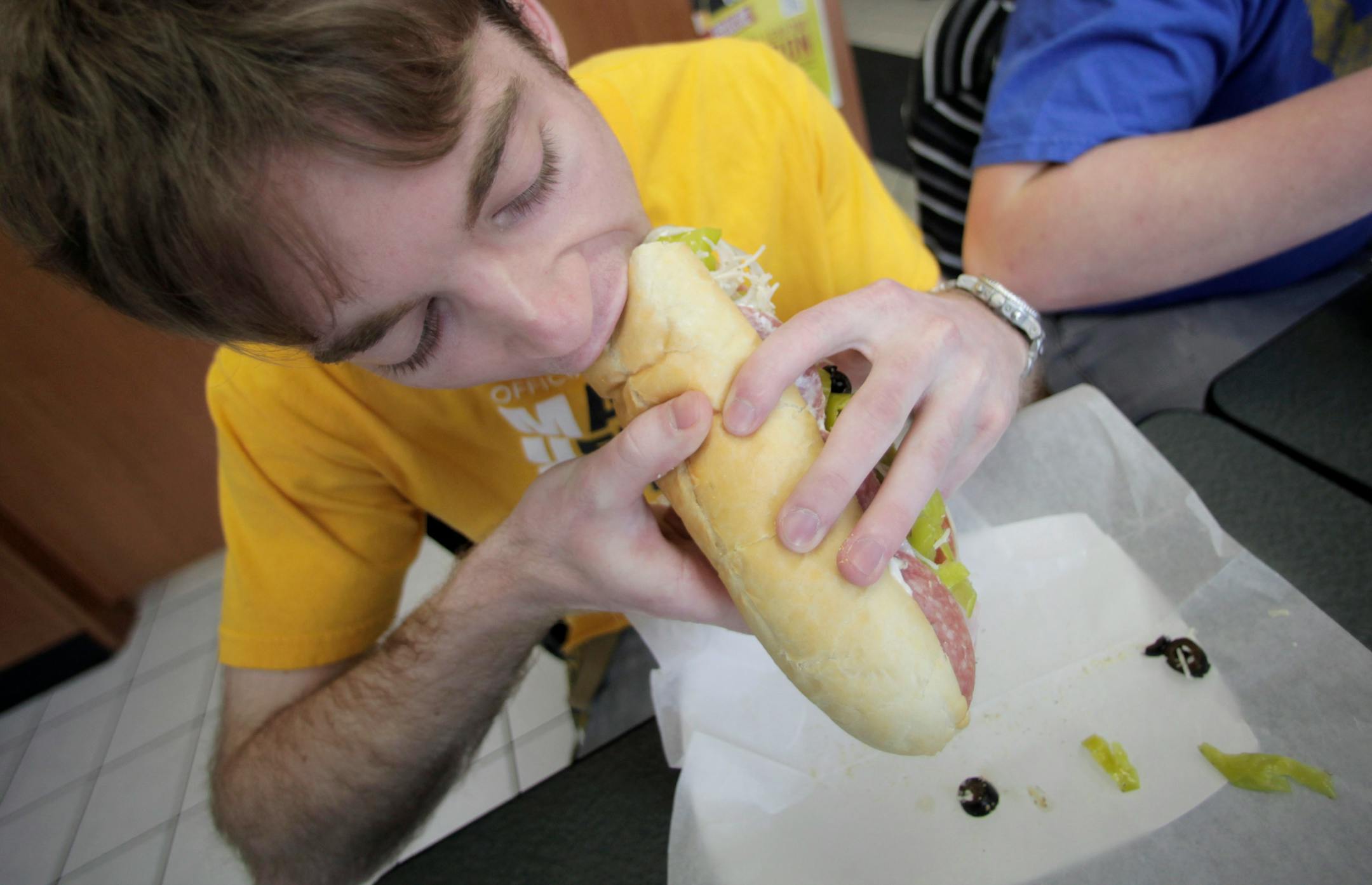 Jason Laqua, a 20-year-old sophomore at Marquette University from Eagan, Minnesota, takes a bite of the Big Daddy sandwich at Cousins Subs, on 1612 W. Wisconsin Avenue on the Marquette University campus on February 27, 2012. (Mike De Sisti/Milwaukee Journal Sentinel/MCT)