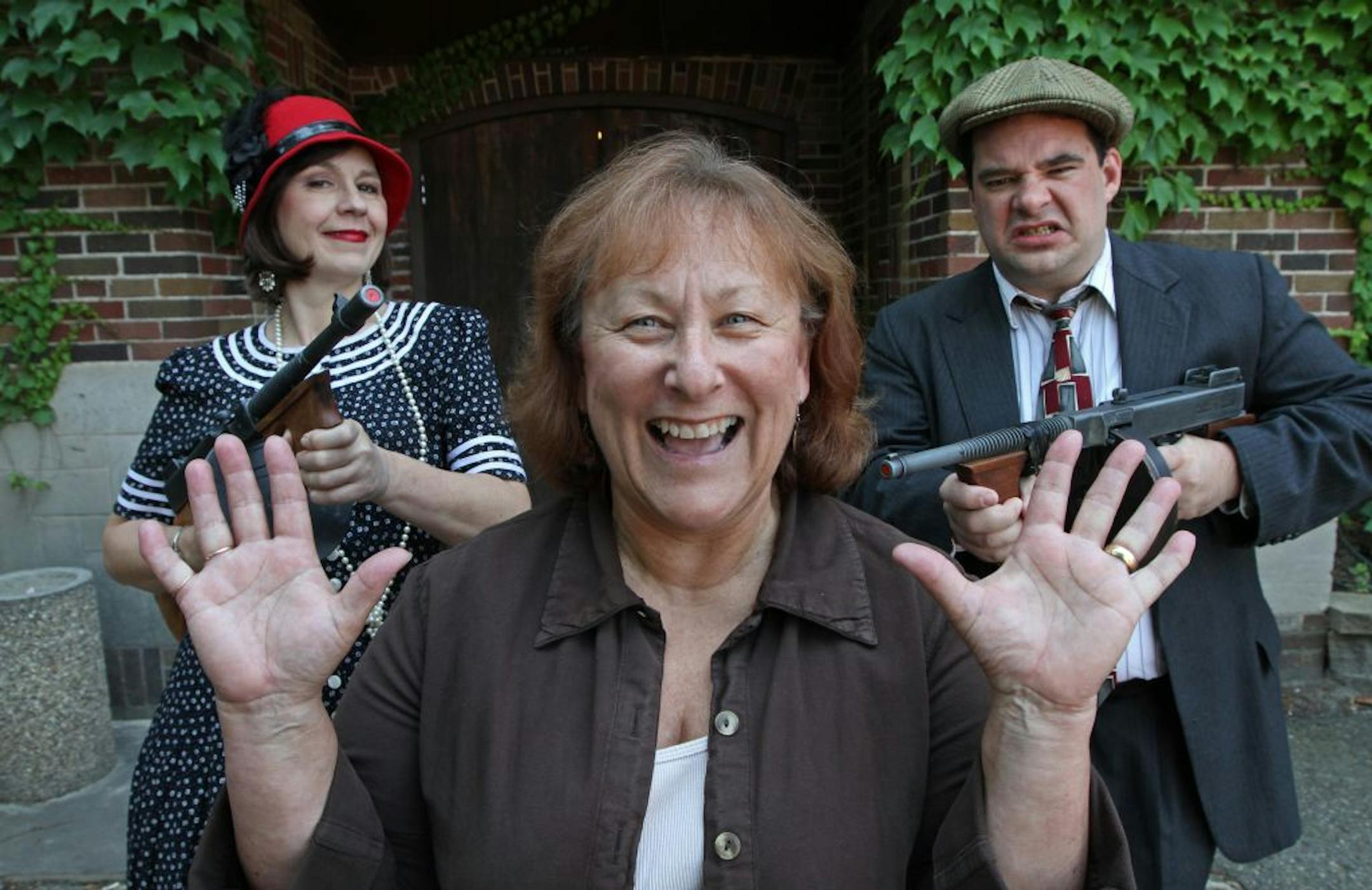 Donna Bremer, co-owner of Down in History Inc., was pleased to resolve a conflict with Twin City Trolleys over a Groupon deal and a trademarked name. Cynthia Smith, left, plays "Murray the Kissing Bandit"; Ryan McArdle plays "Baby Face Nelson."