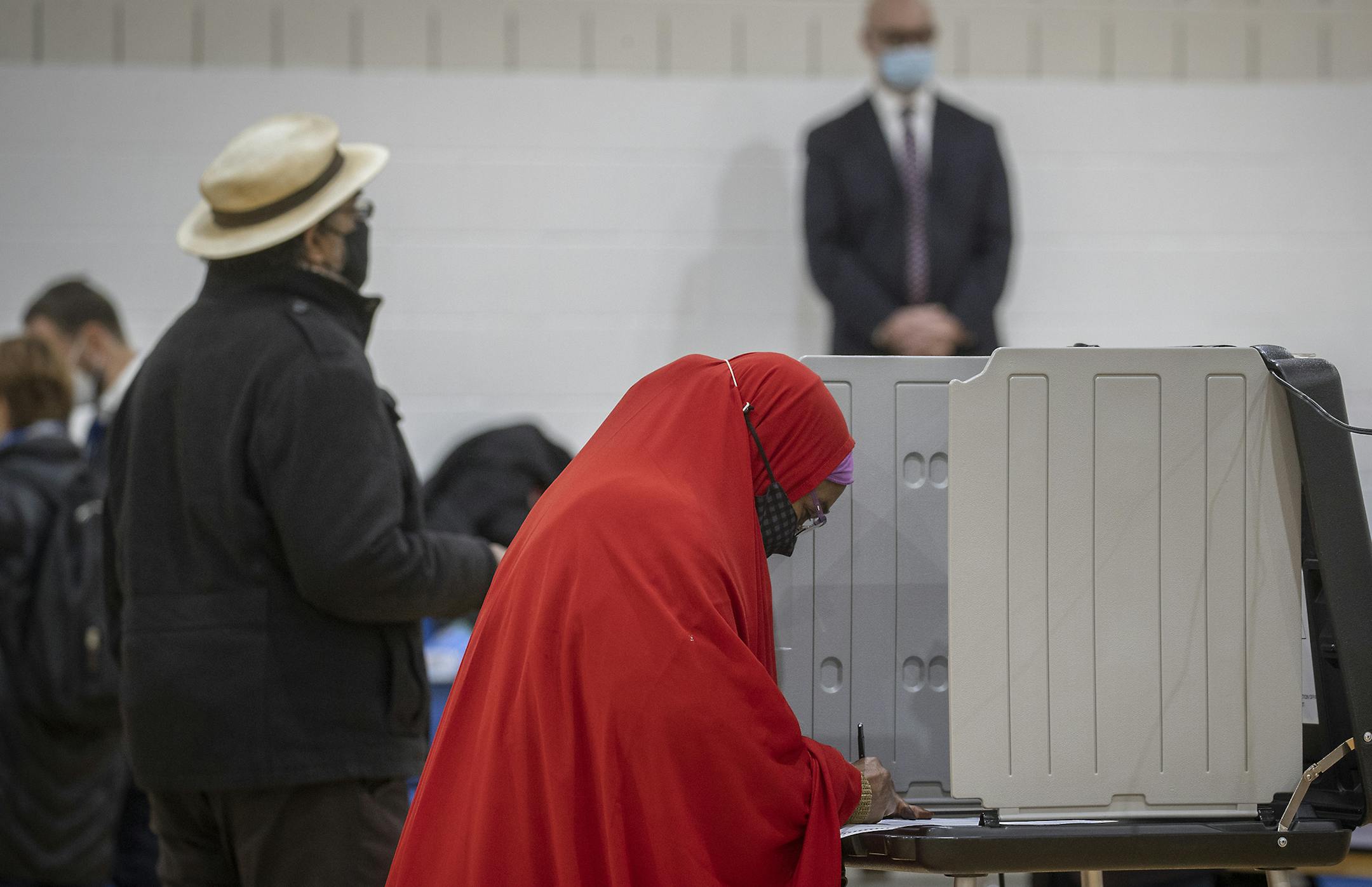 Voters voted and stood in line under the watchful eye of voter challengers at the Brian Coyle Center, Tuesday, November 3, 2020. ] ELIZABETH FLORES • liz.flores@startribune.com