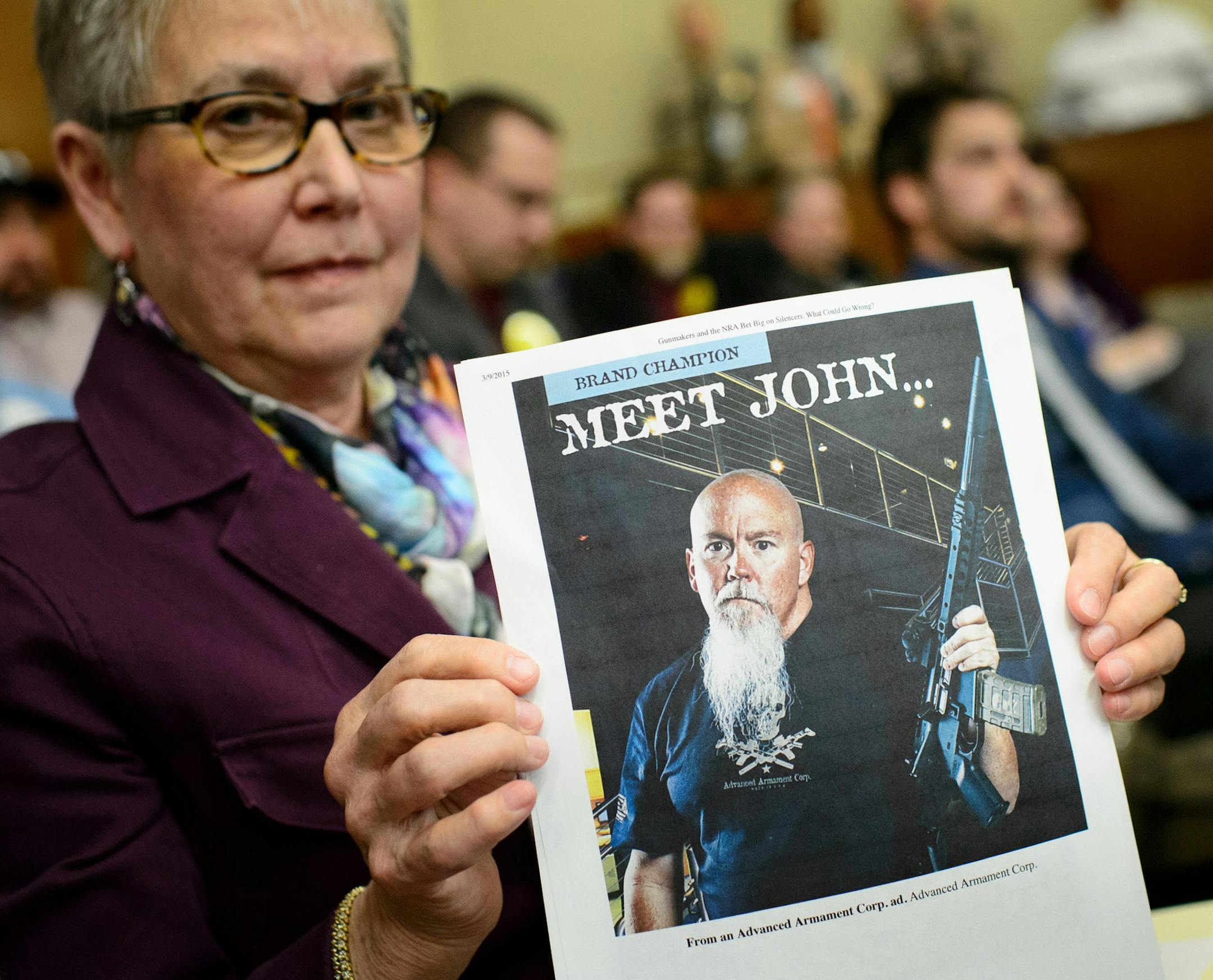 Joan Peterson challenged the notion that the main reason to allow suppressors was to protect shooters hearing by holding up advertisements from suppressor manufacturers that will increase profits if Minnesota lifts the prohibition on their use and posession. ] GLEN STUBBE * gstubbe@startribune.com Thursday, March 12, 2015