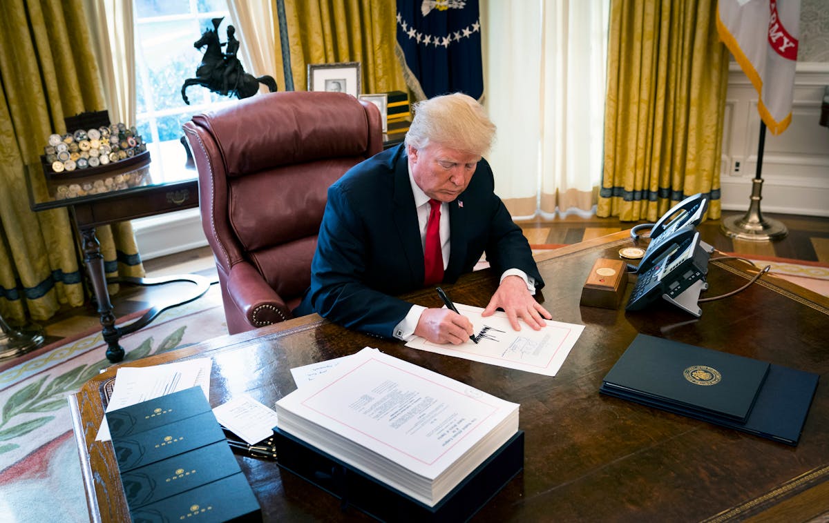 Then-President Donald Trump signs the Tax Cuts and Jobs Act into law at the White House on Dec. 22, 2017.