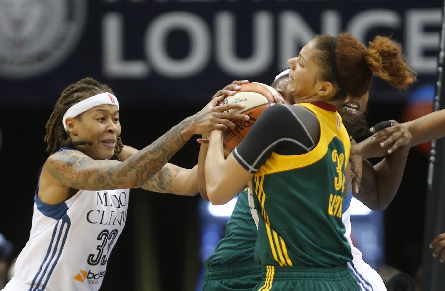 Lynx Seimone Augustus fought for the ball with Seattle's Alysha Clark during the first half. ] (KYNDELL HARKNESS/STAR TRIBUNE) kyndell.harkness@startribune.com Lynx vs Seattle at Target Center in Minneapolis, Min., Friday, July 3, 2015. Lynx won 82-57.