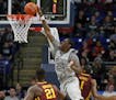 Penn State's Mike Watkins (24) dunks the ball against Minnesota during the second half of an NCAA college basketball game in State College, Pa., Satur