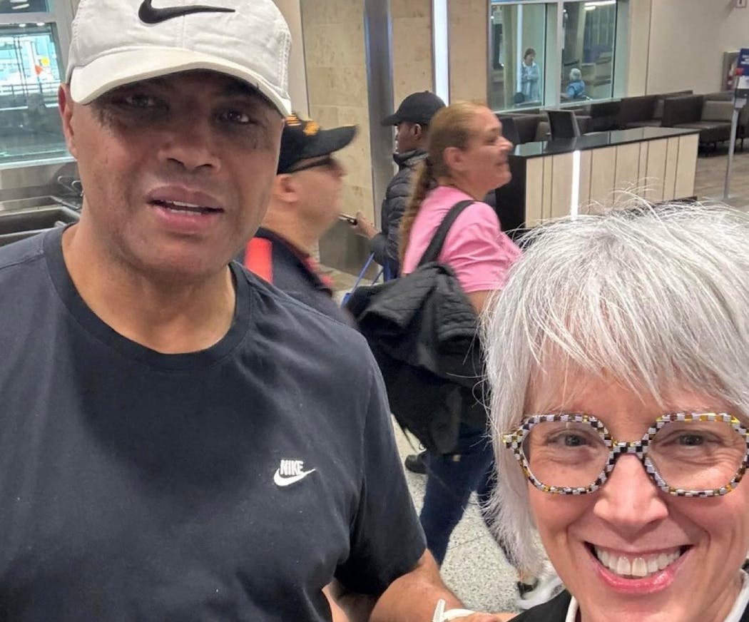 Transportation company employee Amy Mauzy poses with Charles Barkley after he arrived at Minneapolis-St. Paul International Airport earlier this week, prior to the start of the Western Conference finals.