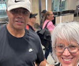 Transportation company employee Amy Mauzy poses with Charles Barkley after he arrived at Minneapolis-St. Paul International Airport earlier this week,