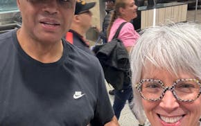 Transportation company employee Amy Mauzy poses with Charles Barkley after he arrived at Minneapolis-St. Paul International Airport earlier this week,