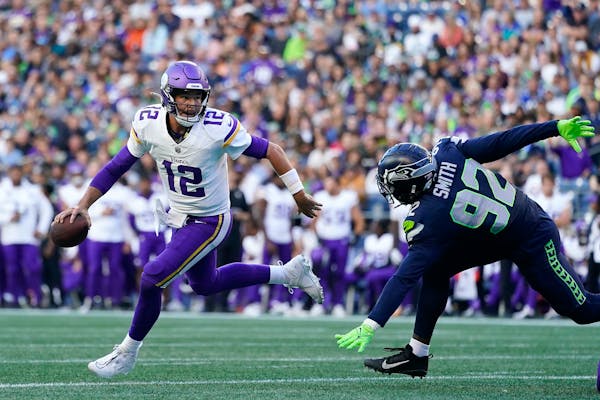 Minnesota Vikings quarterback Nick Mullens (12) scrambles away from Seattle Seahawks linebacker Tyreke Smith (92) during the first half of an NFL pres