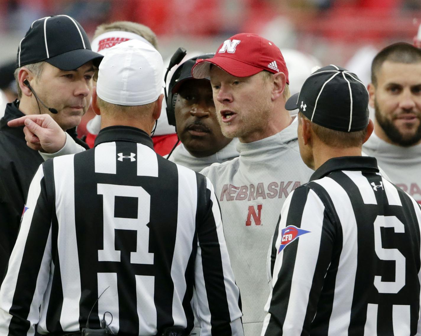 Nebraska head coach Scott Frost, center, exchanges words with Referee Ron Snodgrass and side judge Dominique Pender (S), during the second half of an NCAA college football game against Purdue in Lincoln, Neb., Saturday, Sept. 29, 2018. Purdue won 42-28. (AP Photo/Nati Harnik)