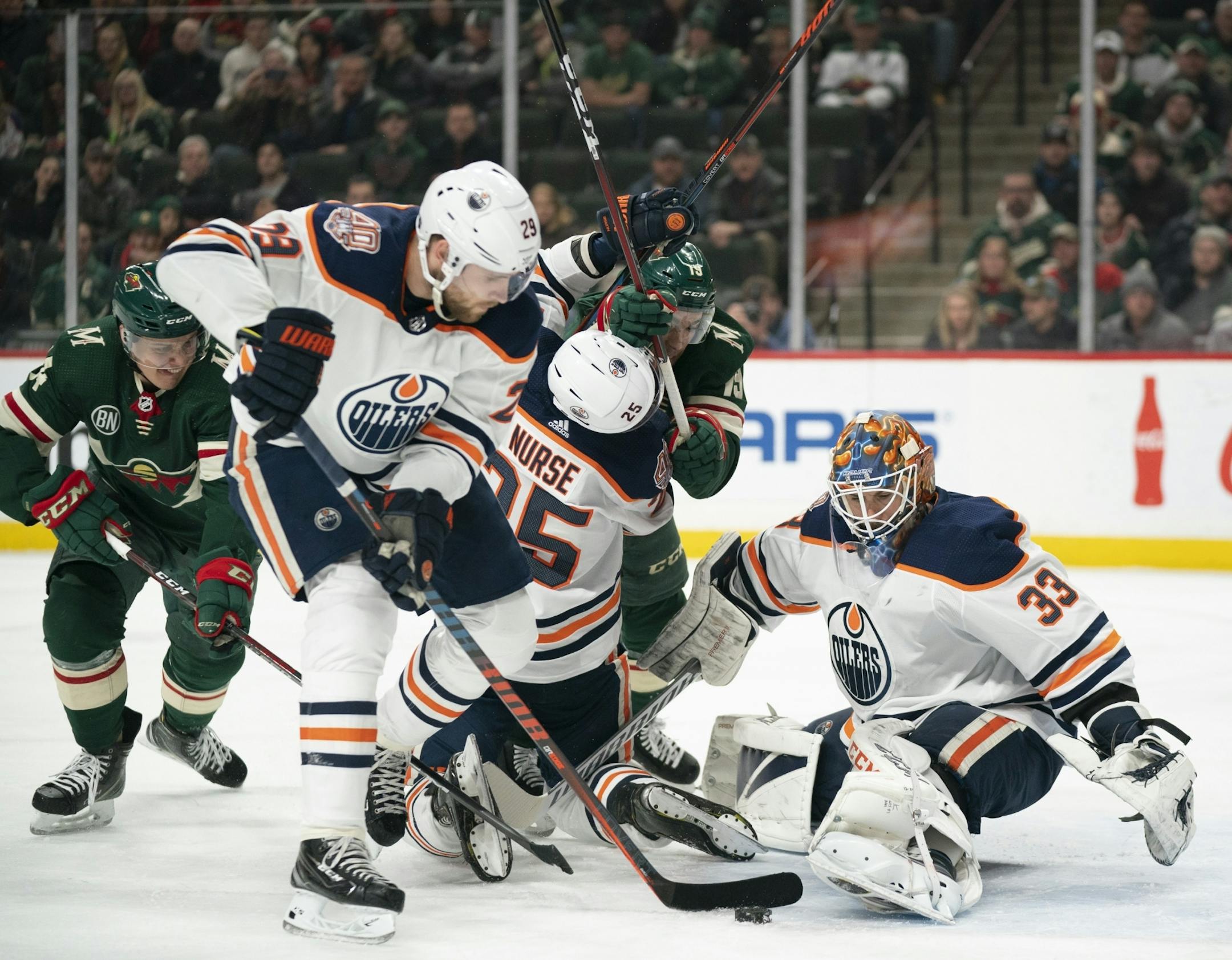 Edmonton Oilers center Leon Draisaitl (29) cleared the puck from in front of Edmonton Oilers goaltender Cam Talbot (33) in the first period.