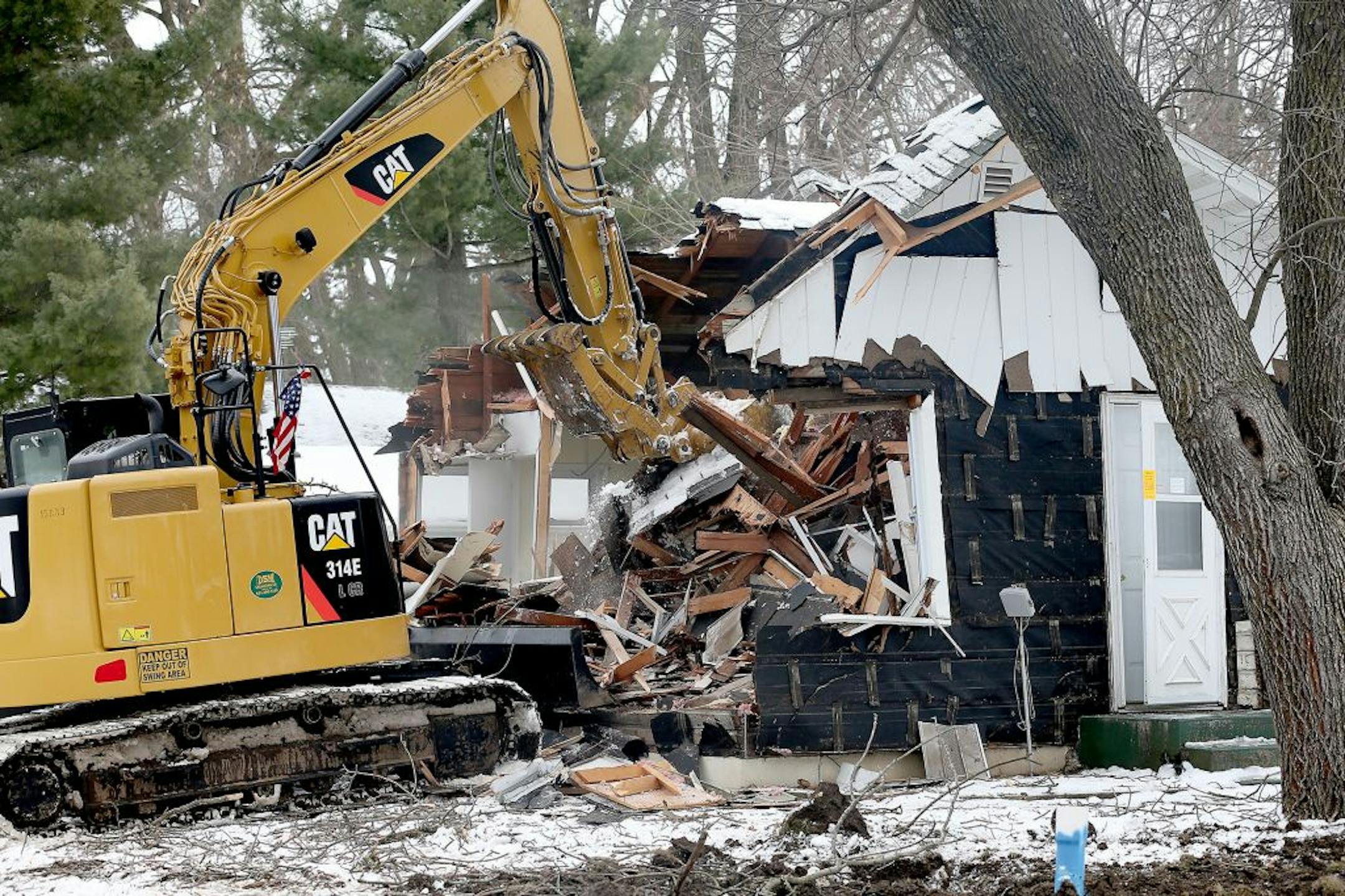 A crew on Friday morning demolished the one-bedroom house on a corner lot in Annandale that once belonged to Danny Heinrich.