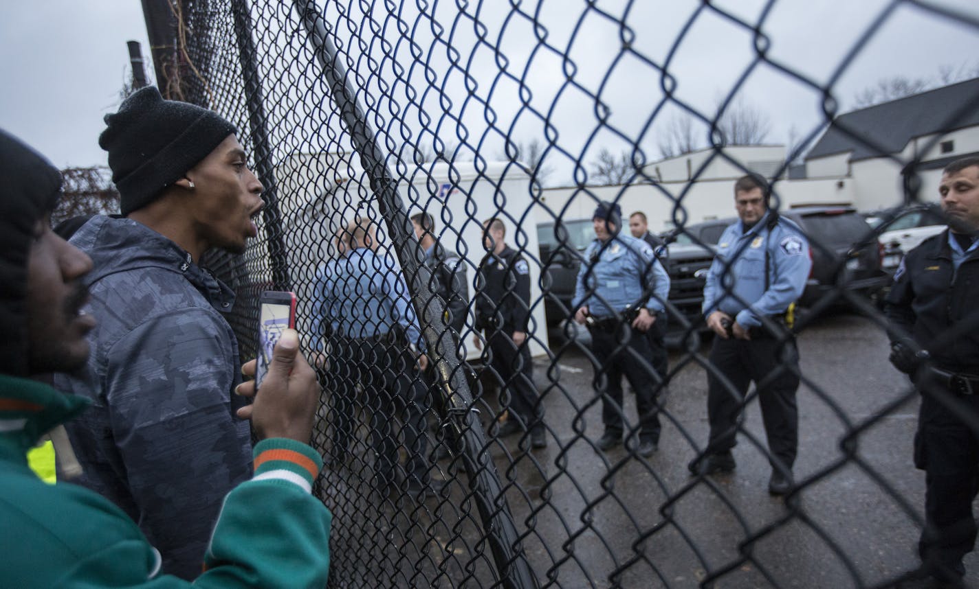 Members of Black Lives Matter and community protesters yelled Wednesday through a gate at the back entrance of the Police Department&#x2019;s Fourth Precinct headquarters in north Minneapolis.