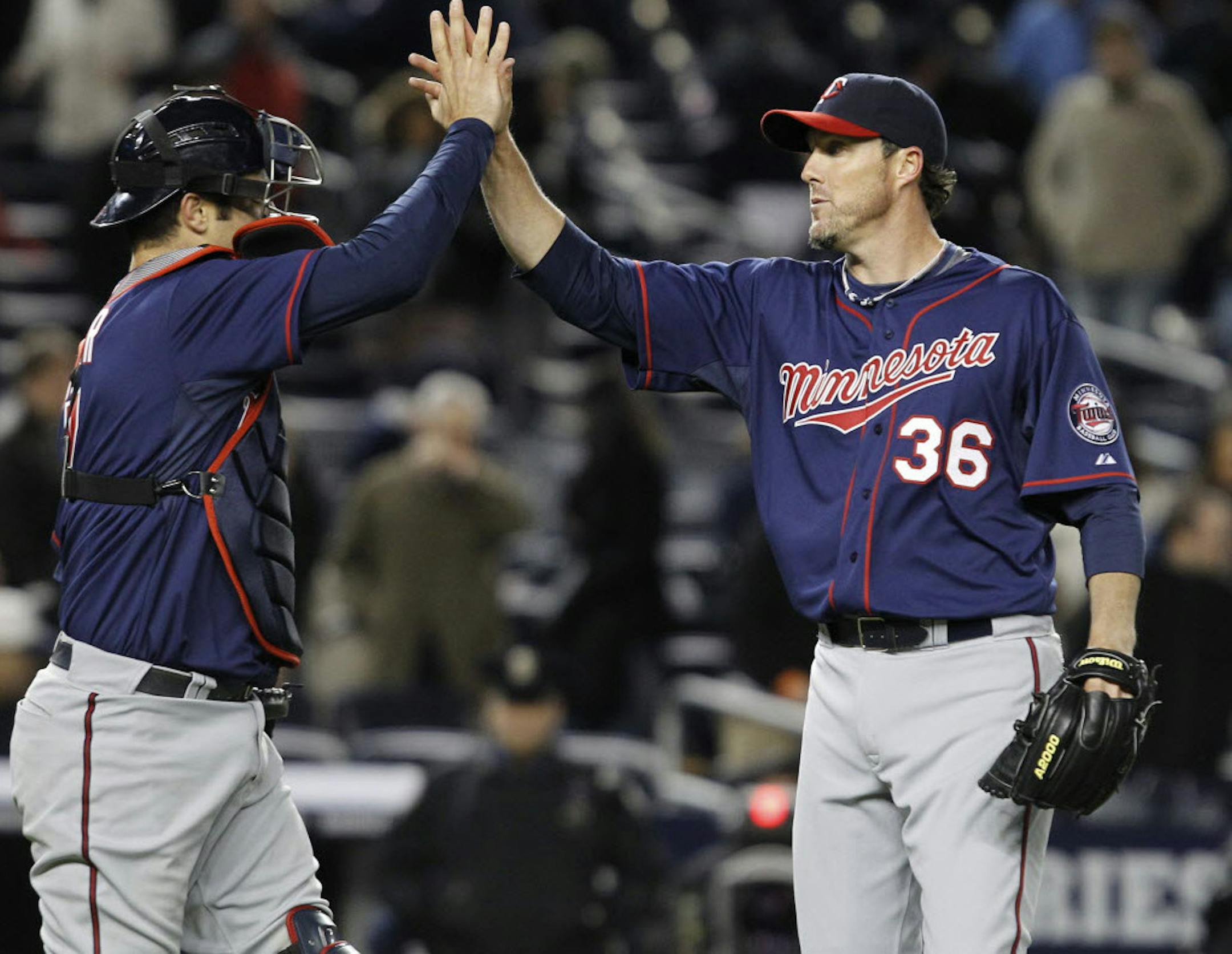 Catcher Joe Mauer and relief pitcher Joe Nathan celebrated the Twins' 5-4, 10-inning victory over the New York Yankees on Tuesday night.