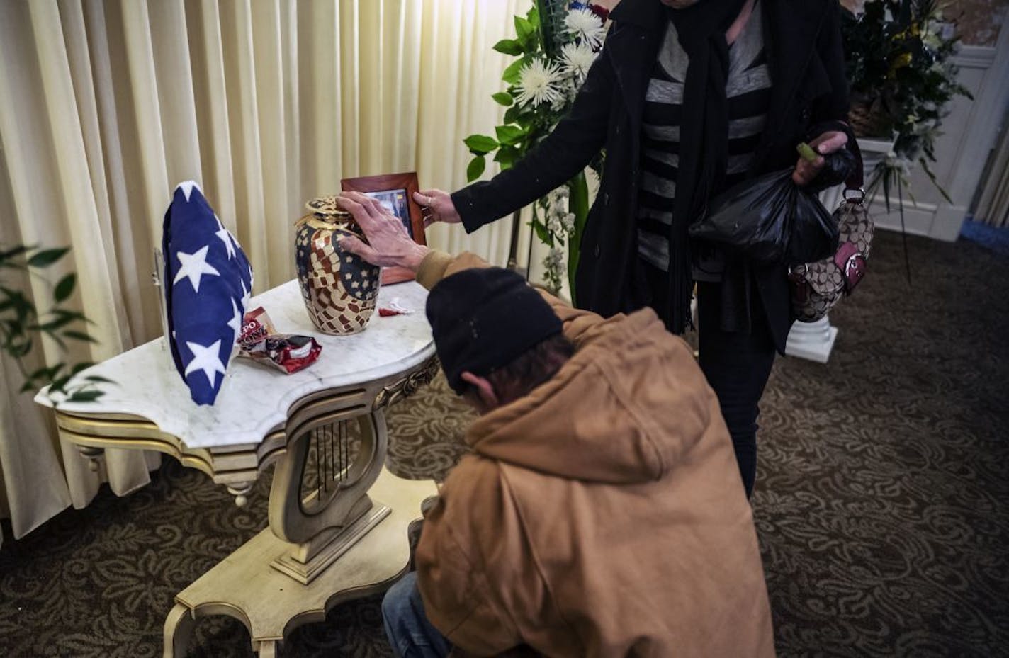 "A brother in arms," said Dan Cramer, a veteran who served 34 years in the Marine Corps and National Guard as he kneeled to pay his respects to Mike (Bones) Hartzell, a Vietnam War veteran. "Just a sweet guy," he said, "he always made sure the sidewalks were clean."