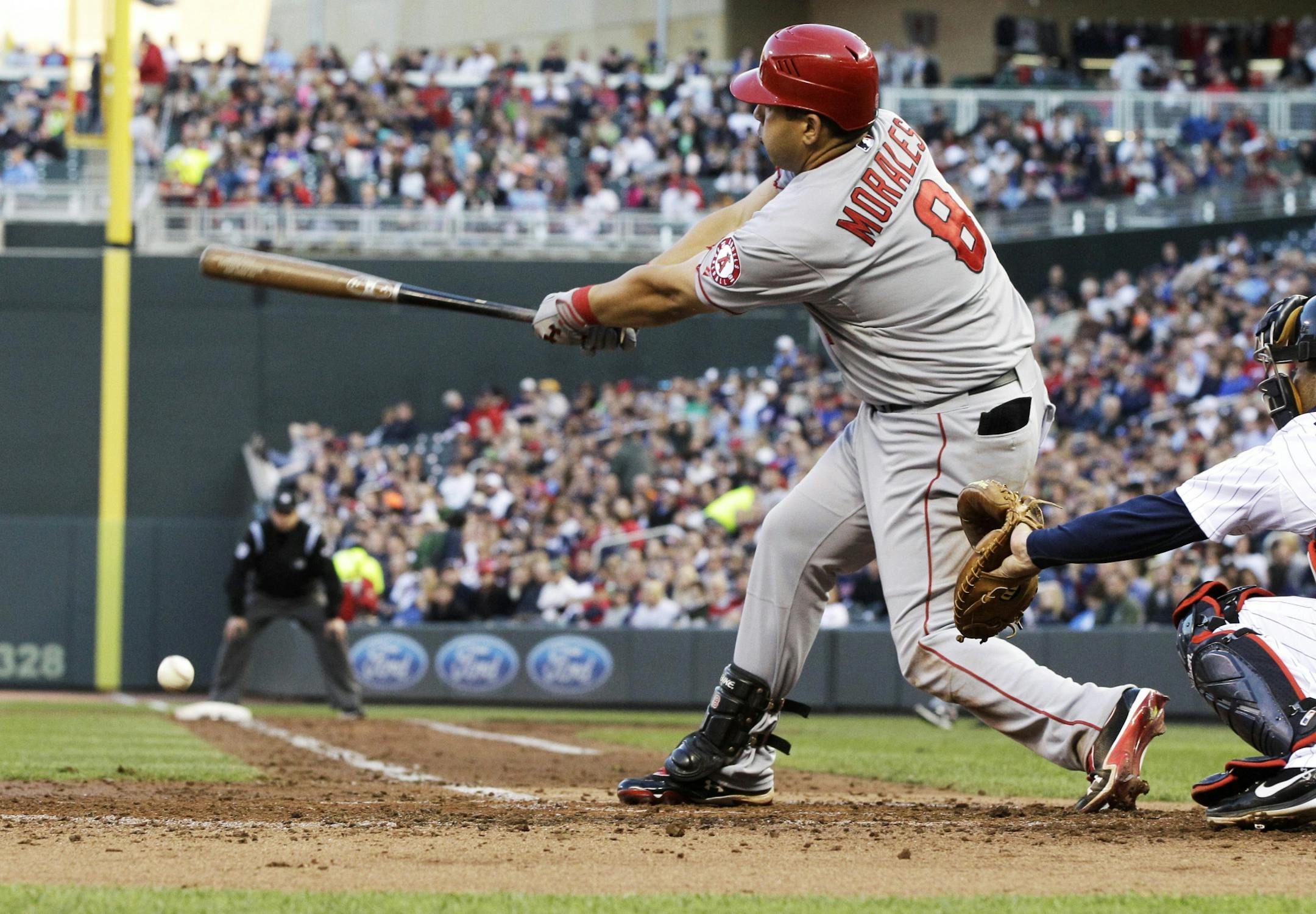 Los Angeles Angels' Kendrys Morales hits an RBI single off Minnesota Twins pitcher Carl Pavano in the third inning of a baseball game Wednesday, May 9, 2012, in Minneapolis.