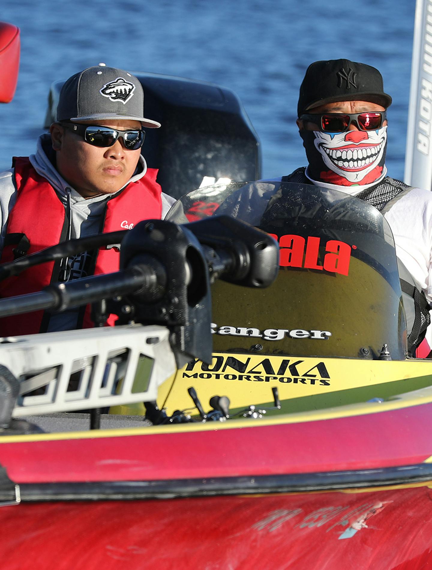 A team of fishermen prepare to launch from Hudson Waterfront Park in Wisconsin. Because of high boat speeds, the fishermen cover their faces. ] (Leila Navidi/Star Tribune) leila.navidi@startribune.com BACKGROUND INFORMATION: The 10th annual Hmong Bass Fishing Tournament on the St. Croix River on Friday, July 1, 2016.