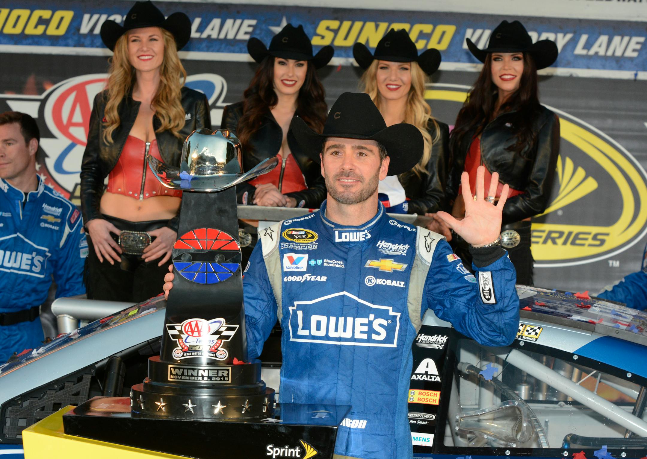 Jimmie Johnson poses for photos in victory lane after winning the NASCAR Sprint Cup Series auto race at Texas Motor Speedway in Fort Worth, Texas, Sunday, Nov. 8, 2015. (AP Photo/Larry Papke)